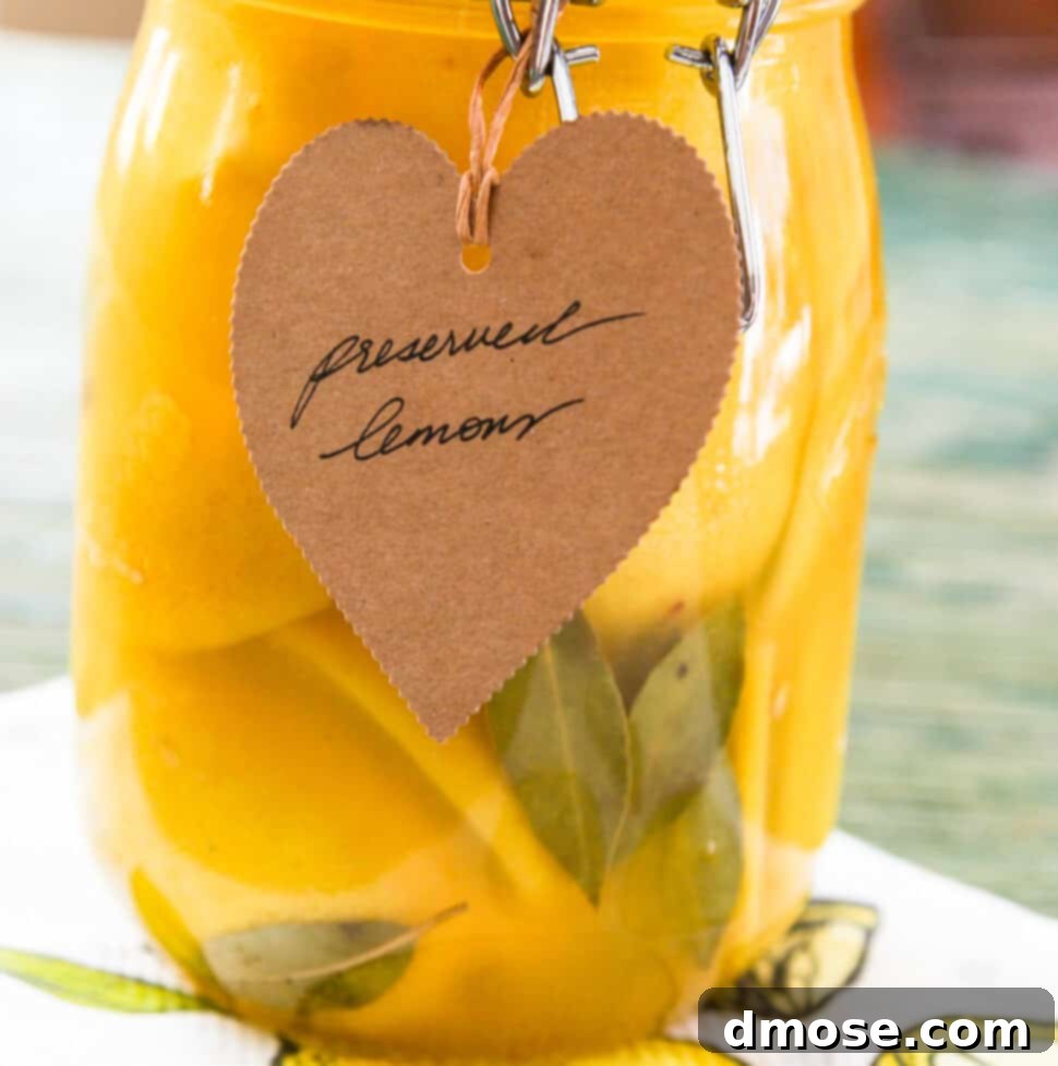 A large clamp jar of Preserved Lemons with a brown craft paper tag that says Preserved Lemons.