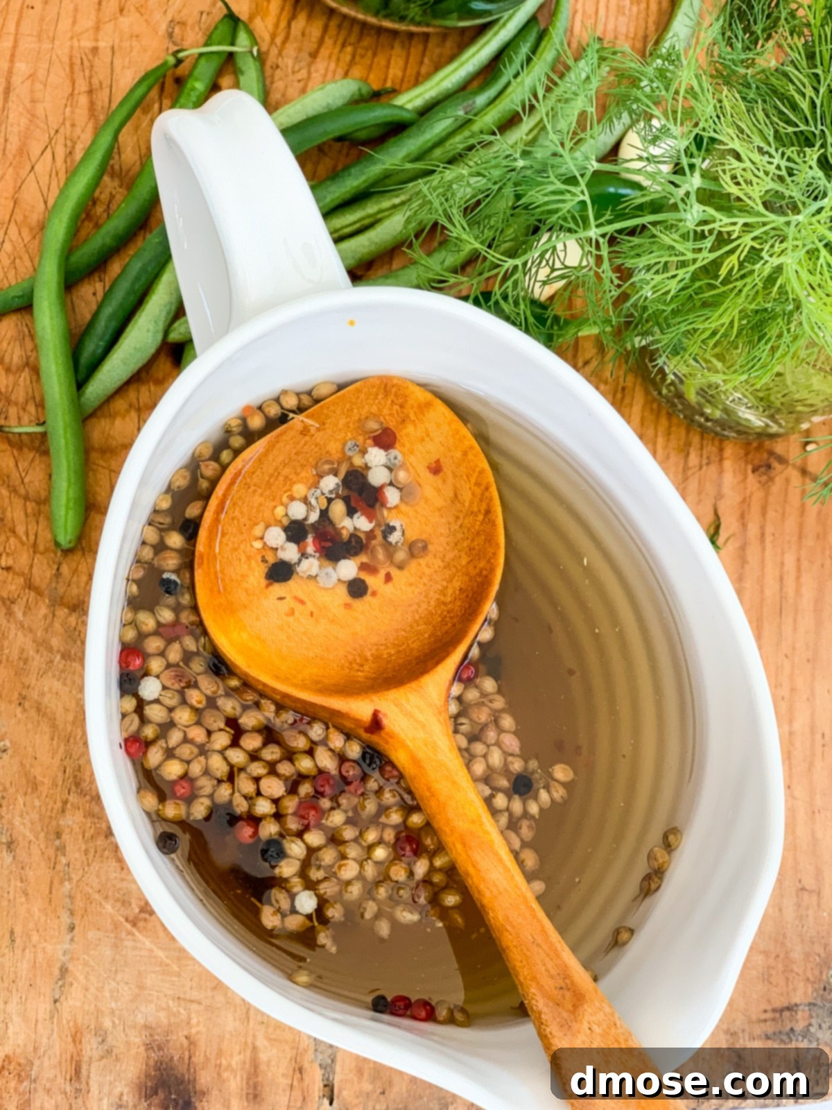 Pickling liquid simmering in a saucepan on the stove.