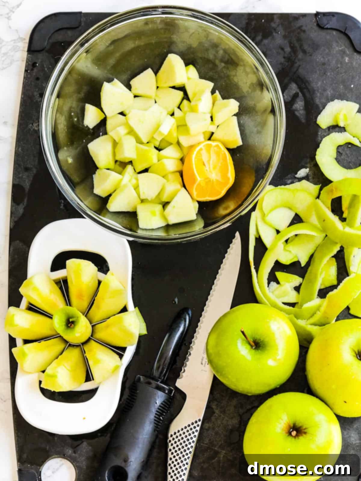 Close-up of apples being peeled and chopped for apple pie filling.