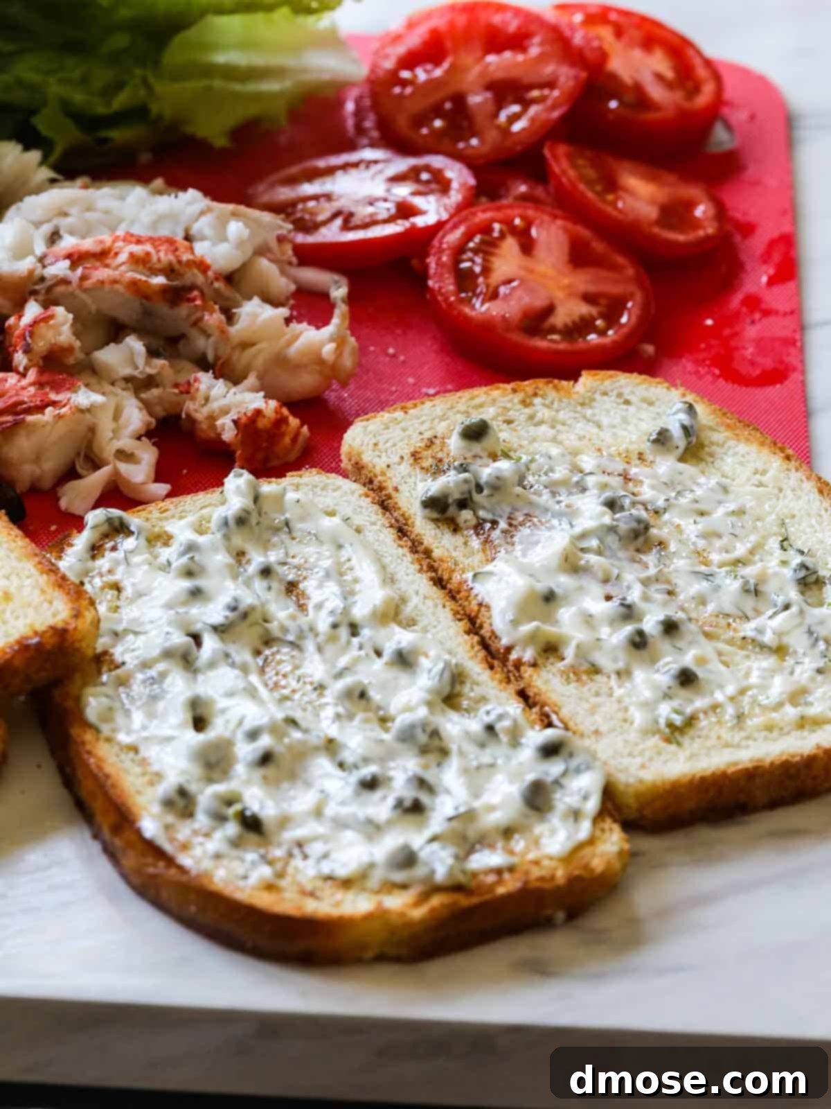 A visual guide showing the careful process of building the BLT lobster sandwich, with each fresh ingredient being meticulously layered.
