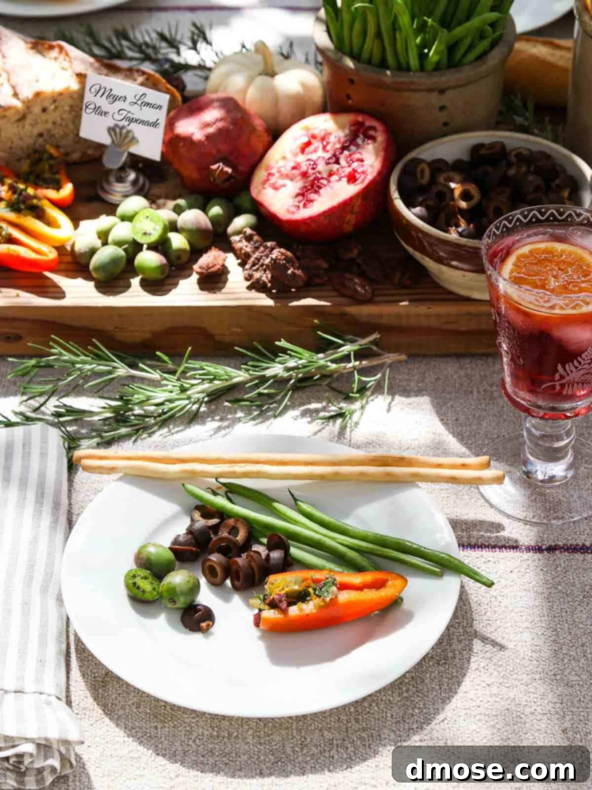 A beautifully presented Meyer Lemon Olive Tapenade appetizer, served with a small plate of crostini at a party setting.