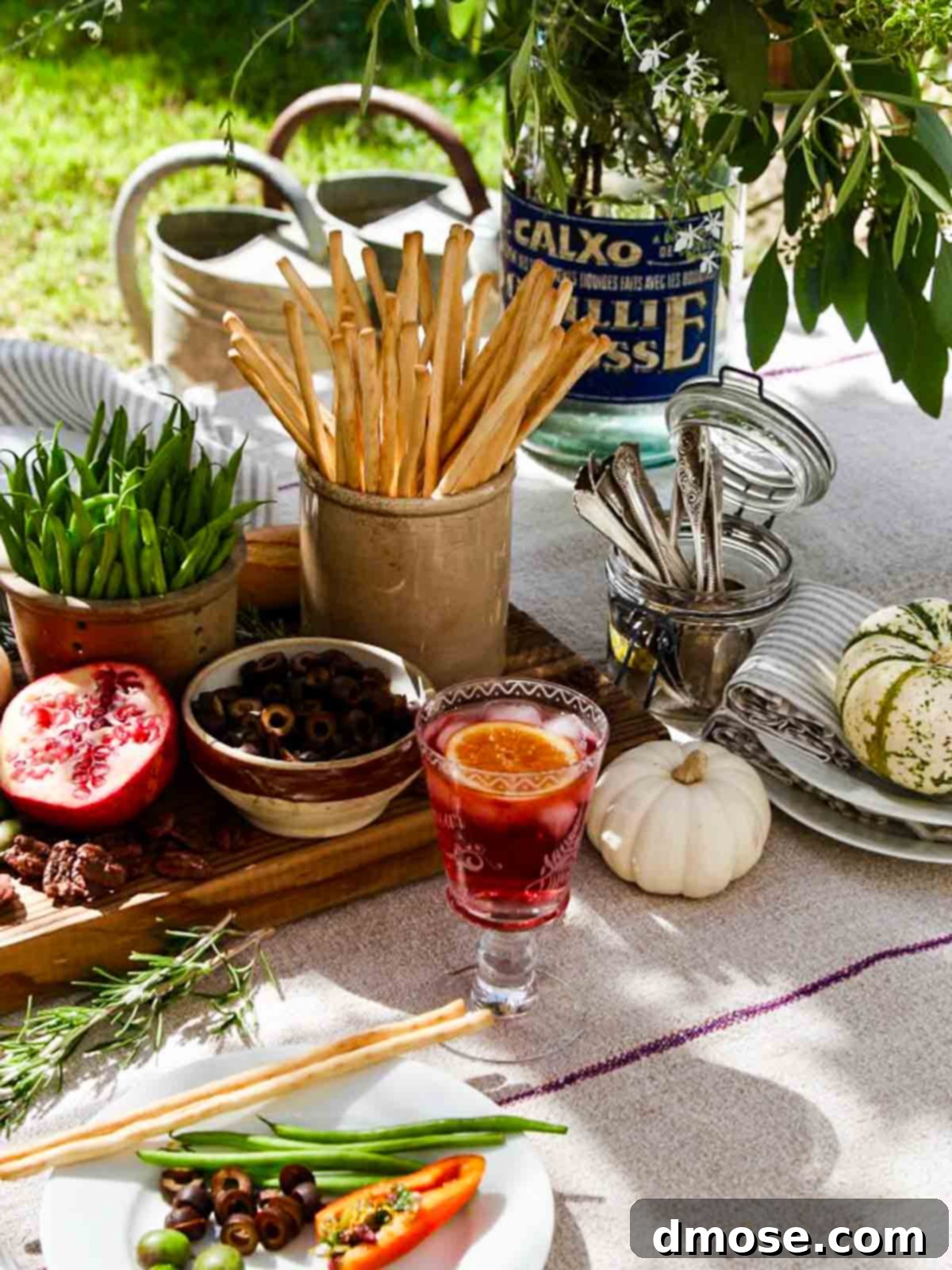 A beautifully arranged appetizer party table featuring Meyer Lemon Tapenade as a central dish, surrounded by other gourmet treats.