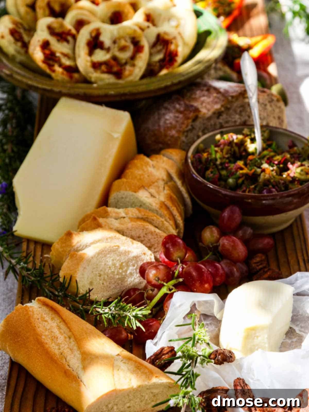 An inviting outdoor appetizer table at a party, featuring a bowl of Meyer Lemon Olive Tapenade alongside other delectable treats.