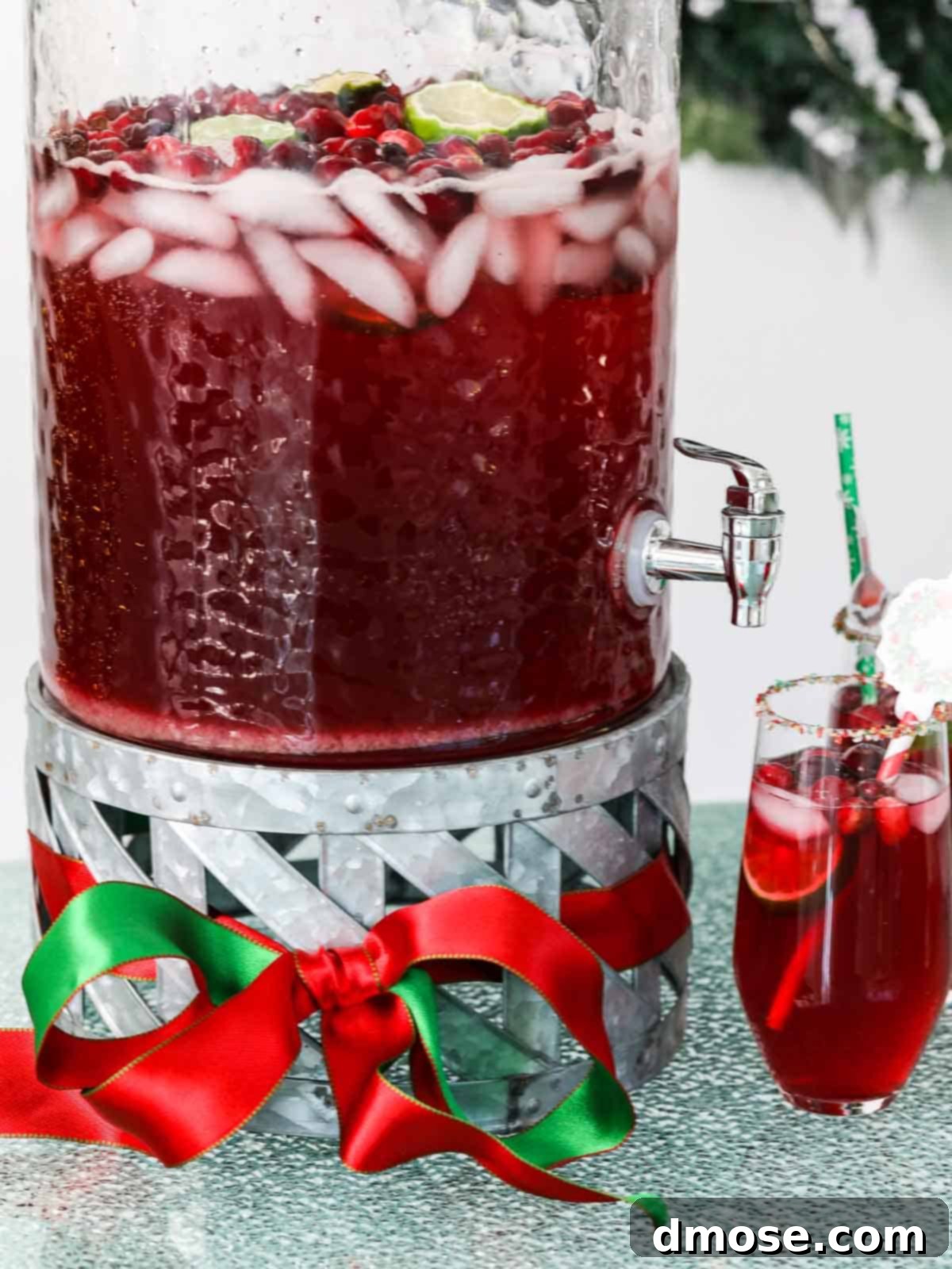 A beautifully set table with glasses of Christmas Punch, garnished with a festive red bow.