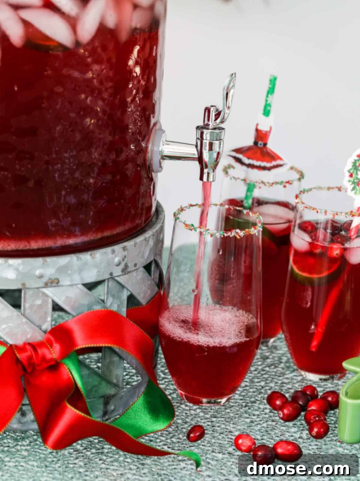 Pouring Christmas Punch into a glass, showing the beautiful bubbles and inviting red color.