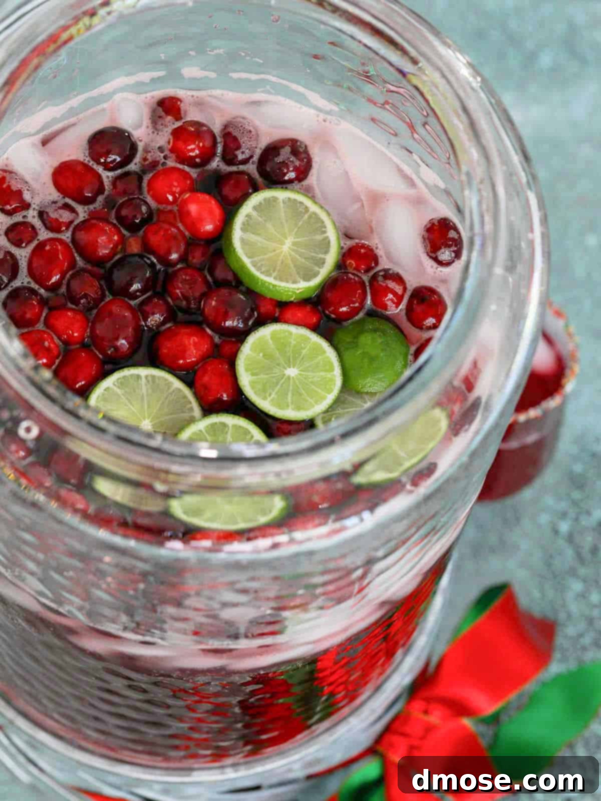 A large beverage dispenser filled with non-alcoholic Christmas Punch, perfect for a holiday gathering.