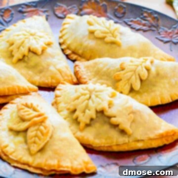 Effortlessly Delicious Turkey Breast 10 Golden brown baked empanadas decorated with pie crust leaves on a Fall tray.