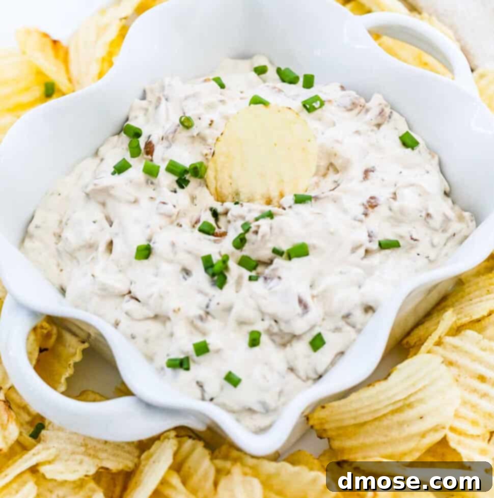 Ruffled potato chips on a plate with homemade French onion dip.