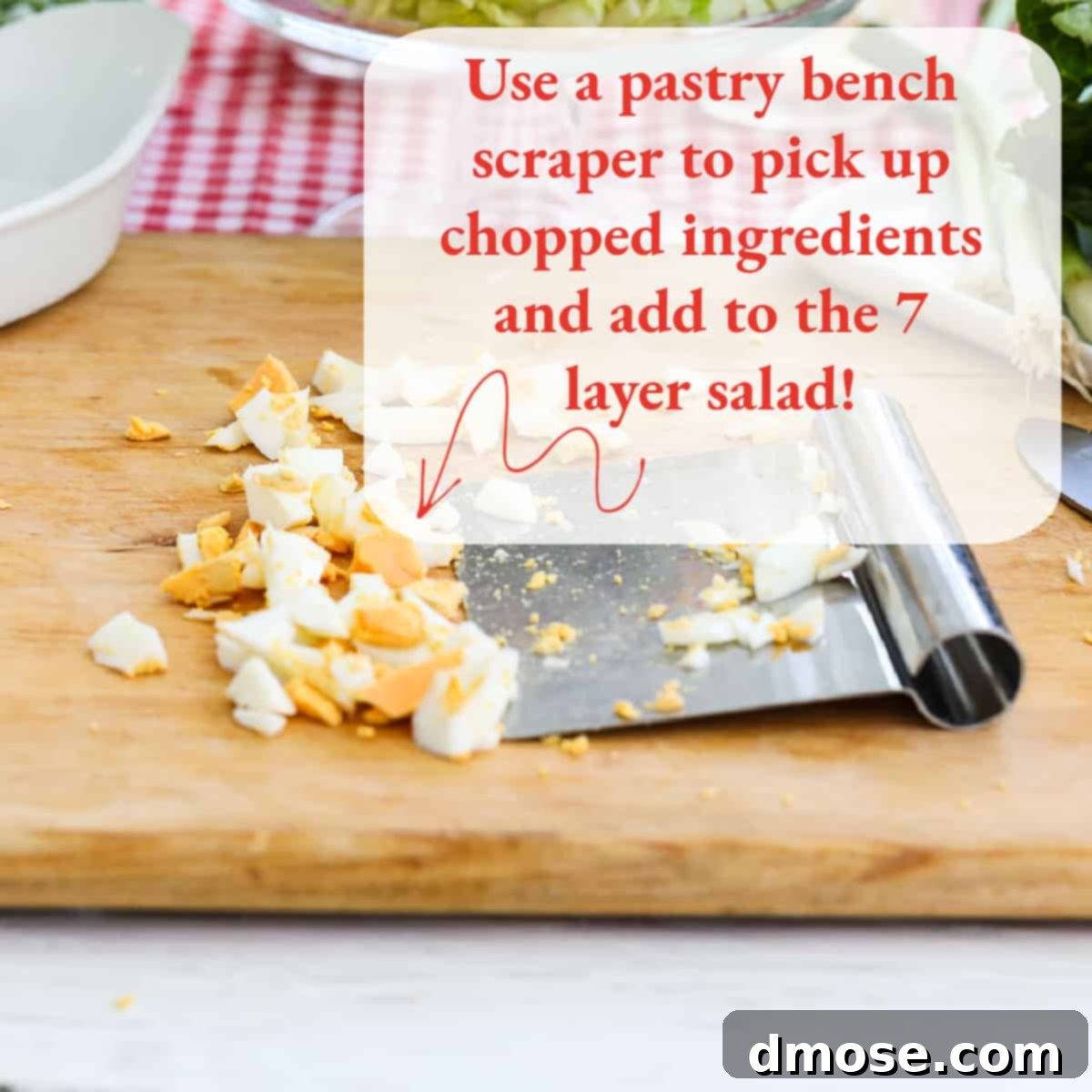 A pastry bench scraper demonstrating how to neatly transfer chopped ingredients.