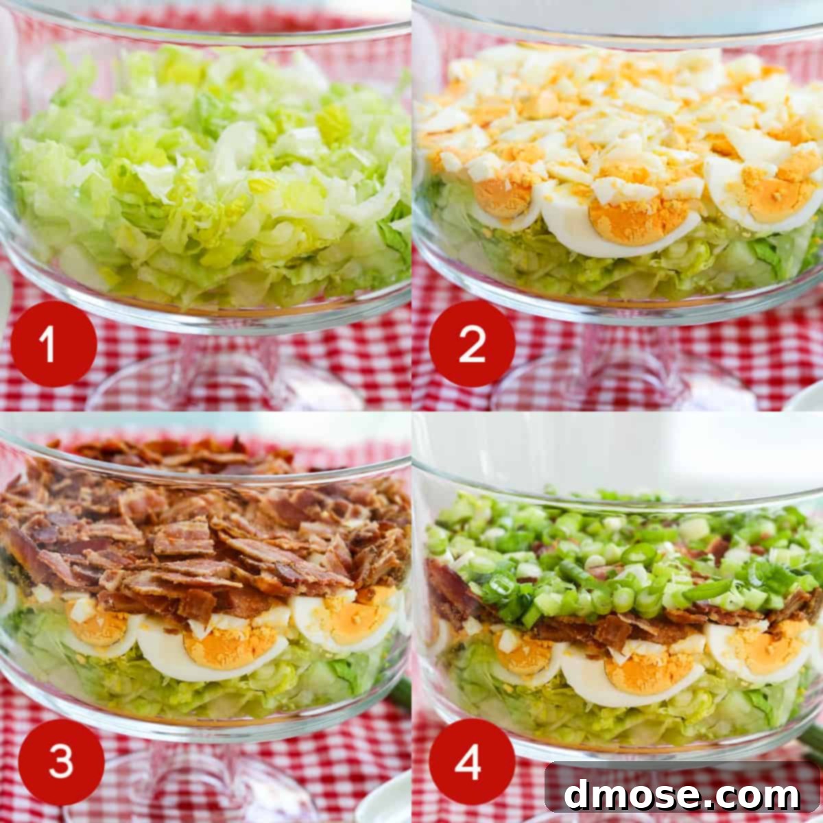 A layered salad in progress, showing the distinct layers of lettuce, eggs, bacon, and green onions.