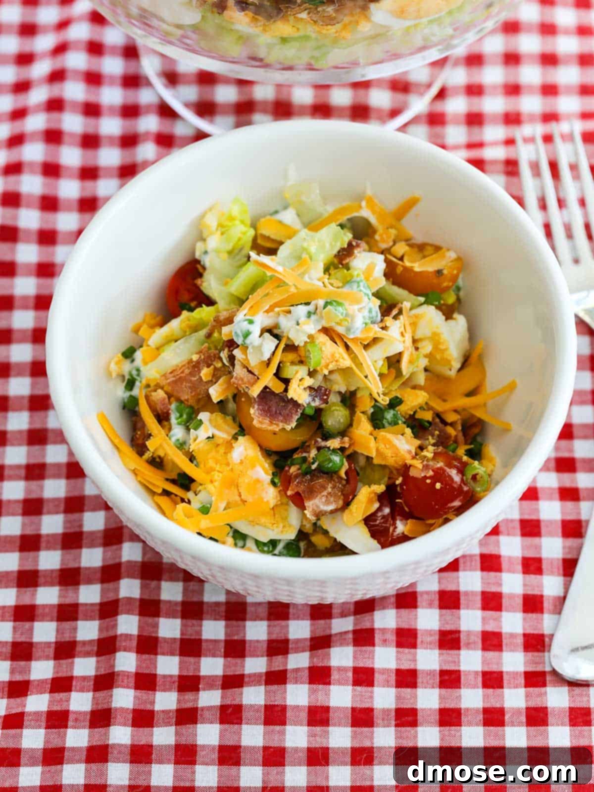 A serving of 7 Layer Salad scooped into a smaller bowl, showing the delightful mix of ingredients.