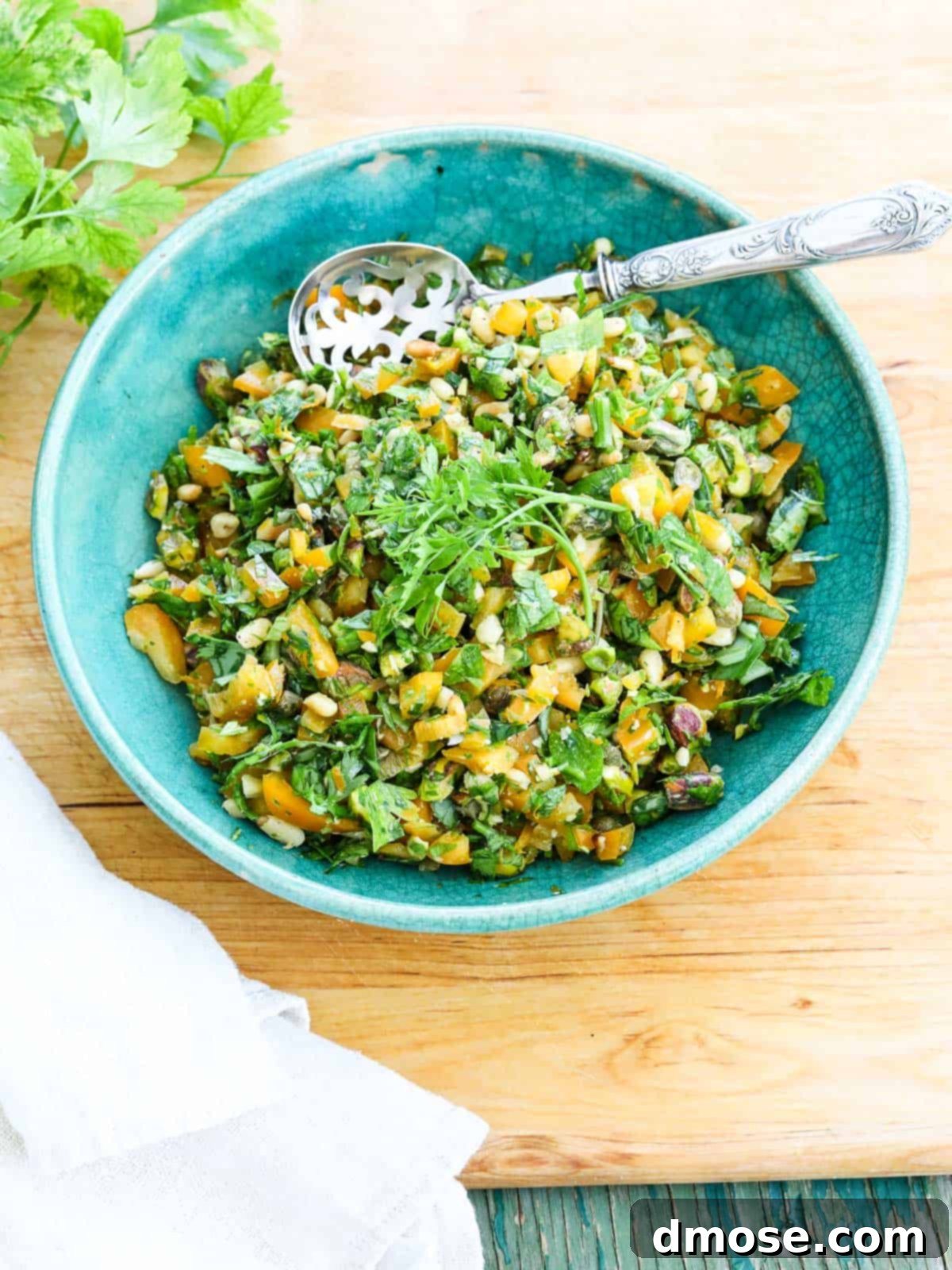 Freshly made Gremolata in a bowl, ready to serve, garnished with herbs.