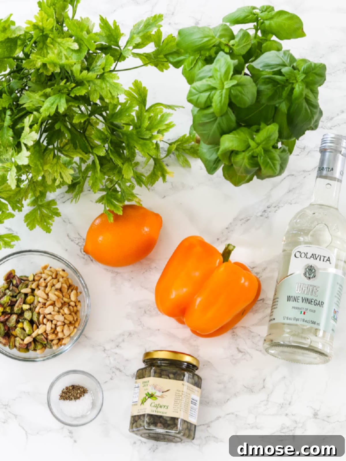 Fresh produce and ingredients spread on a kitchen counter, ready for making gremolata.