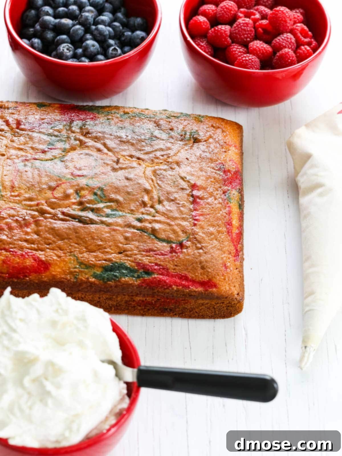 A baked red, white, and blue marbled American Flag Cake, ready for frosting.