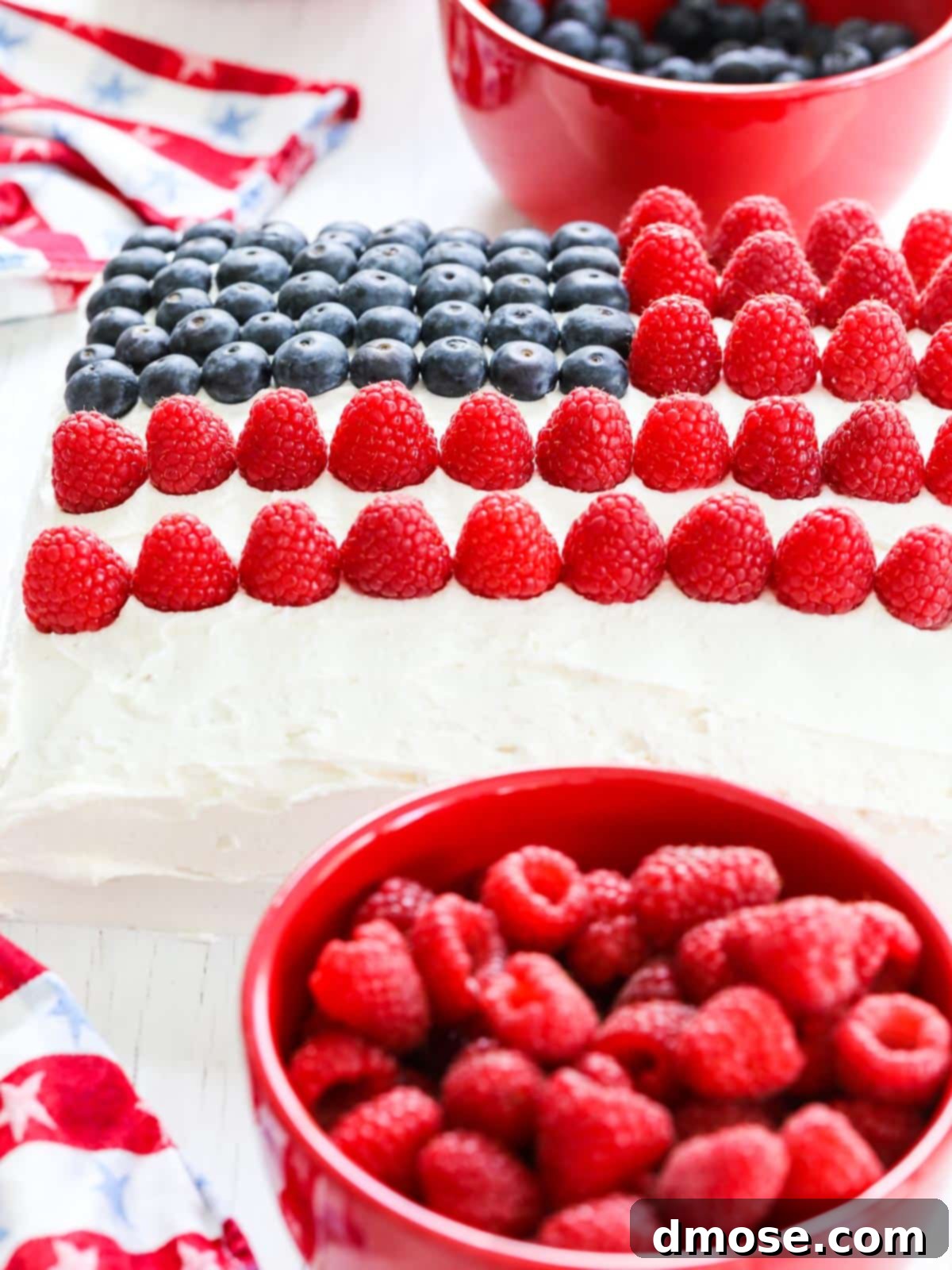 Decorating an American Flag Cake with raspberries to form the red stripes.