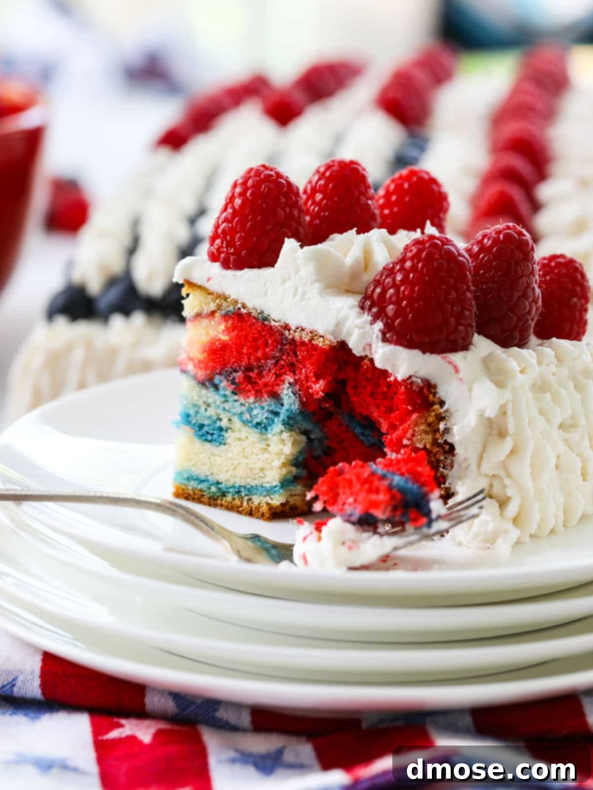 A slice of American Flag Cake revealing the red, white, and blue marbled interior.