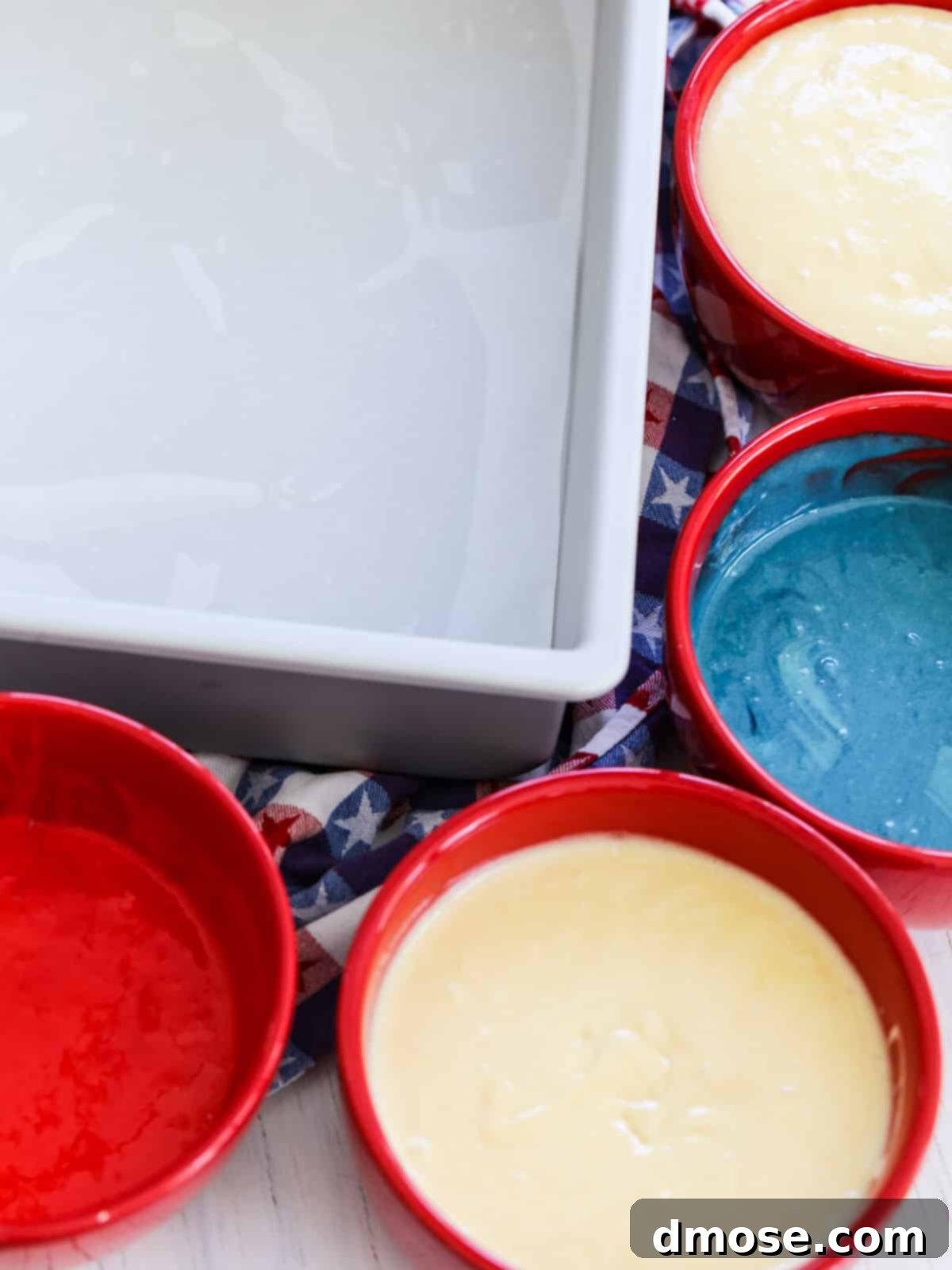 Red, white, and blue cake batter prepared in a pan for baking an American Flag Cake.