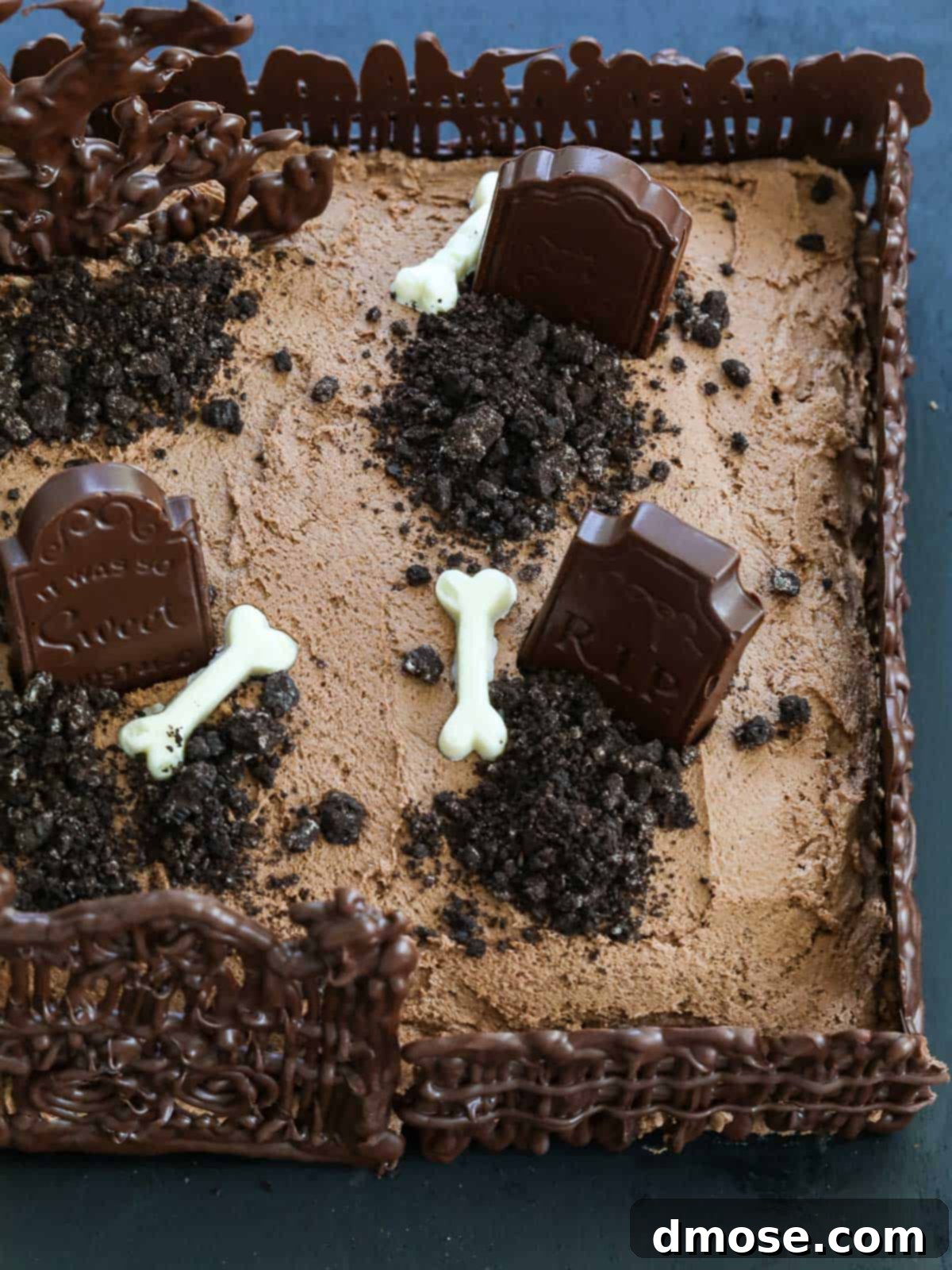 Haunted Halloween Cake Delights 3 An overhead shot of the Halloween Graveyard Cake, showcasing the detailed edible chocolate decorations and the 'dirt' made from crushed Oreos.