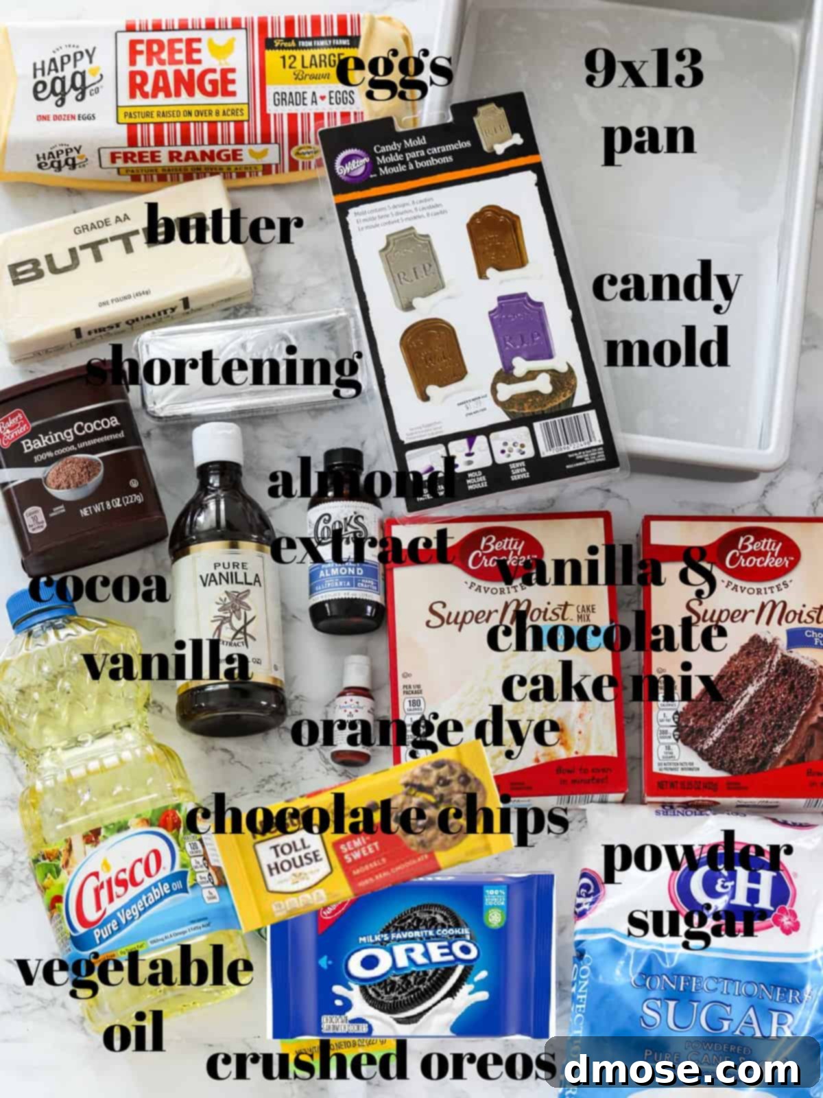 Haunted Halloween Cake Delights 4 A collection of ingredients laid out on a table, including cake mixes, butter, cocoa powder, chocolate chips, and orange food coloring, ready for baking the Halloween cake.