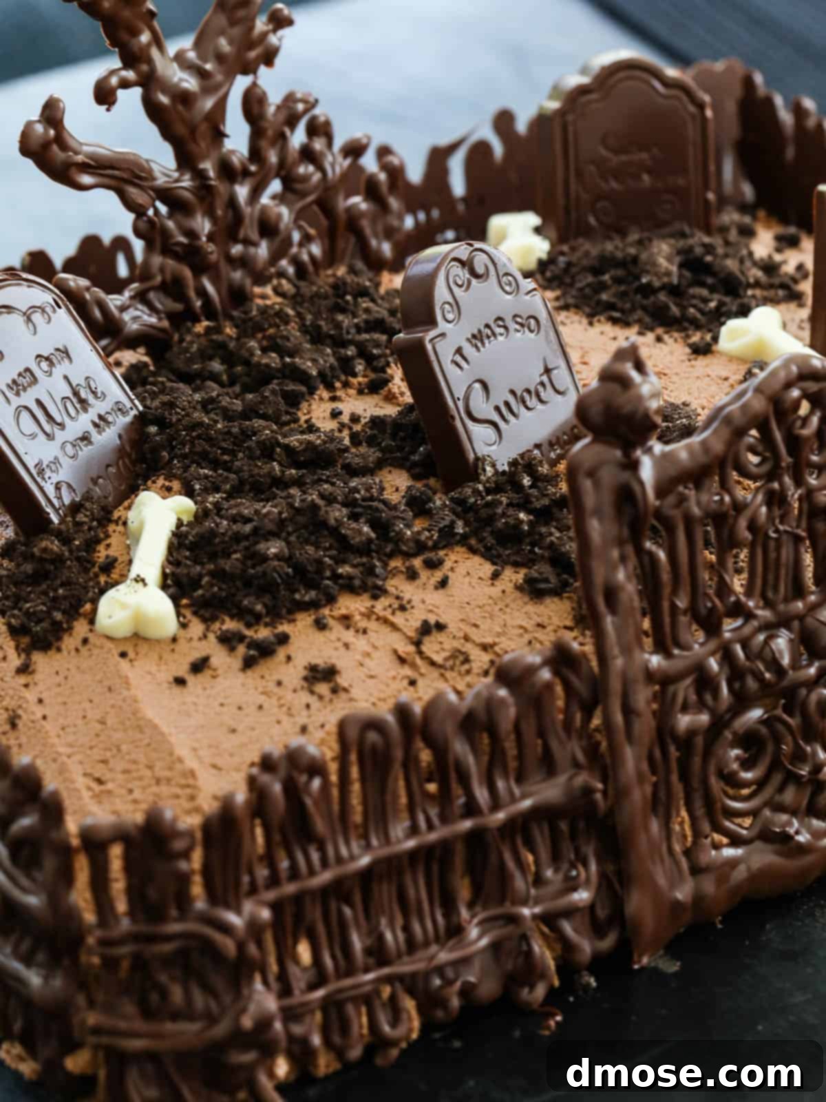 Haunted Halloween Cake Delights 10 The fully decorated Halloween Graveyard Cake, showcasing the chocolate tree, fence, tombstones, and 'dirt', ready to be served.