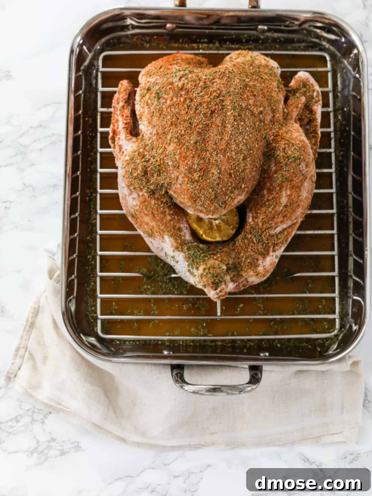A roasted turkey on a roasting pan, ready for carving.