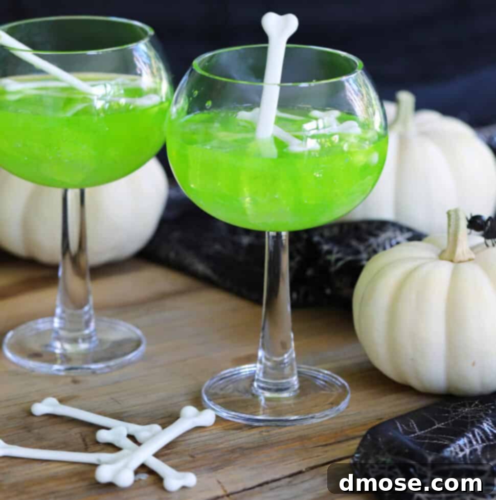 Mystic Melon Elixir 8 A Halloween party scene with two vibrant green cocktails made with Midori, garnished with whimsical white plastic bones, showcasing the Witches Brew Midori Sour for festive Halloween cocktails.