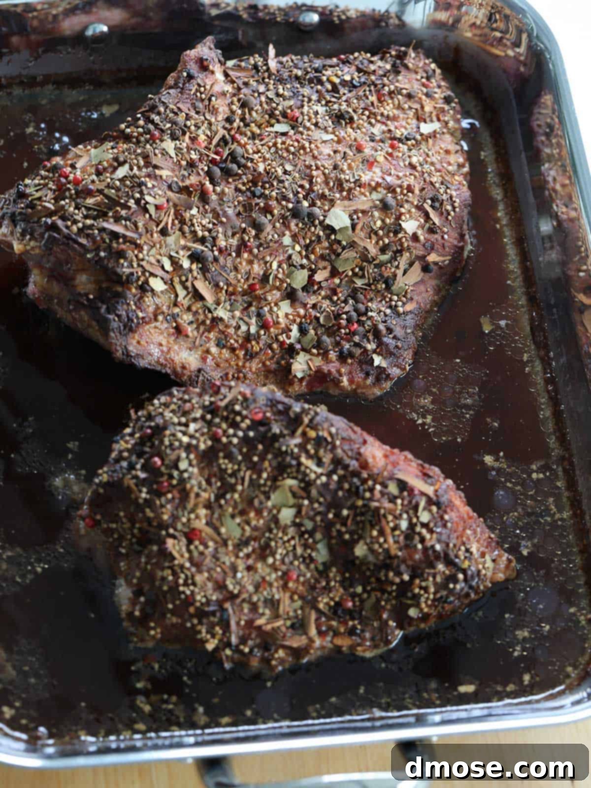 Slow-Cooked Corned Beef Perfection 14 Cooked corned beef cuts in roast pan.