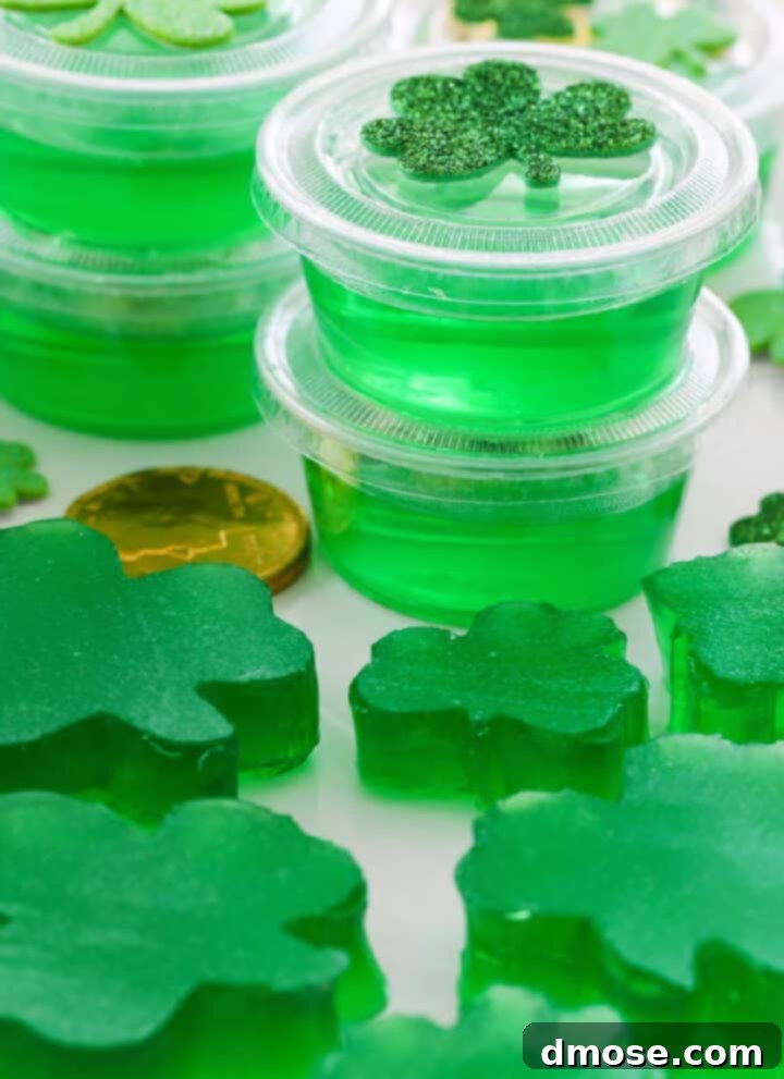 Slow-Cooked Corned Beef Perfection 24 A white rectangle platter with green jello shots and jigglers shaped like shamrocks.