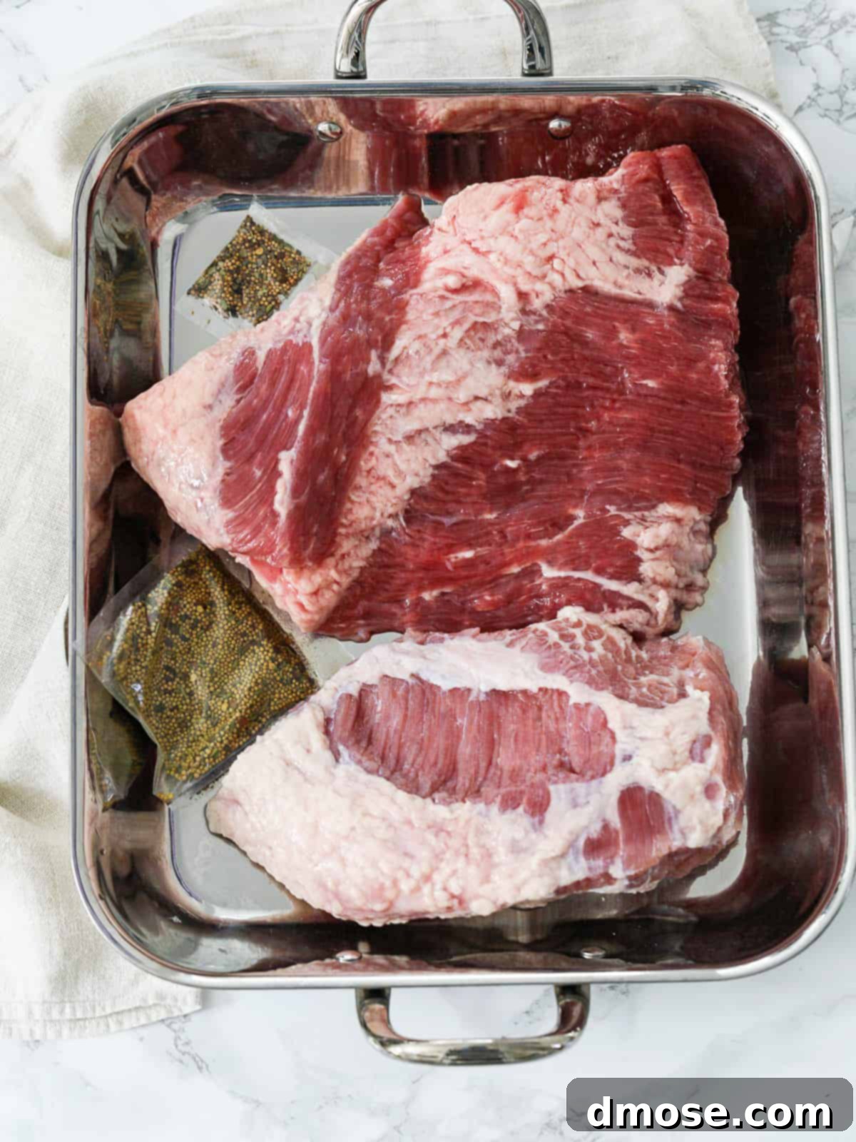 Slow-Cooked Corned Beef Perfection 8 Corned Beef cuts in roasting pan.