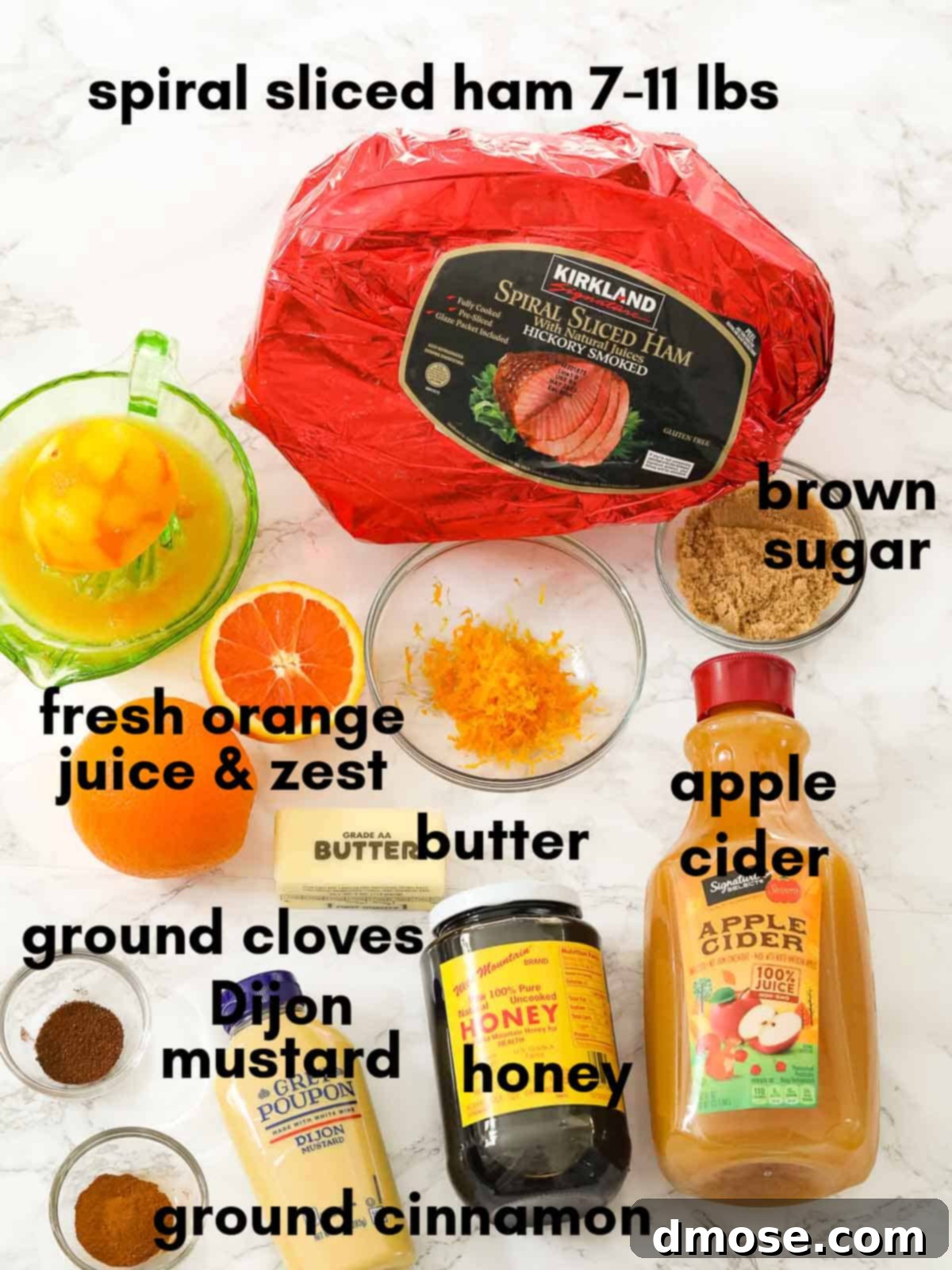 Rich Double Smoked Ham Zesty Orange Honey Glazed 4 All the ingredients for the spiral double smoked ham glaze laid out on a table, including spices, honey, orange, butter, and apple cider.