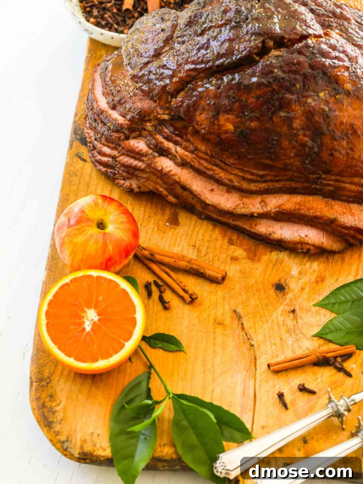 Rich Double Smoked Ham Zesty Orange Honey Glazed 10 An overhead shot of a perfectly smoked ham, beautifully glazed and resting on a cutting board, ready for serving.