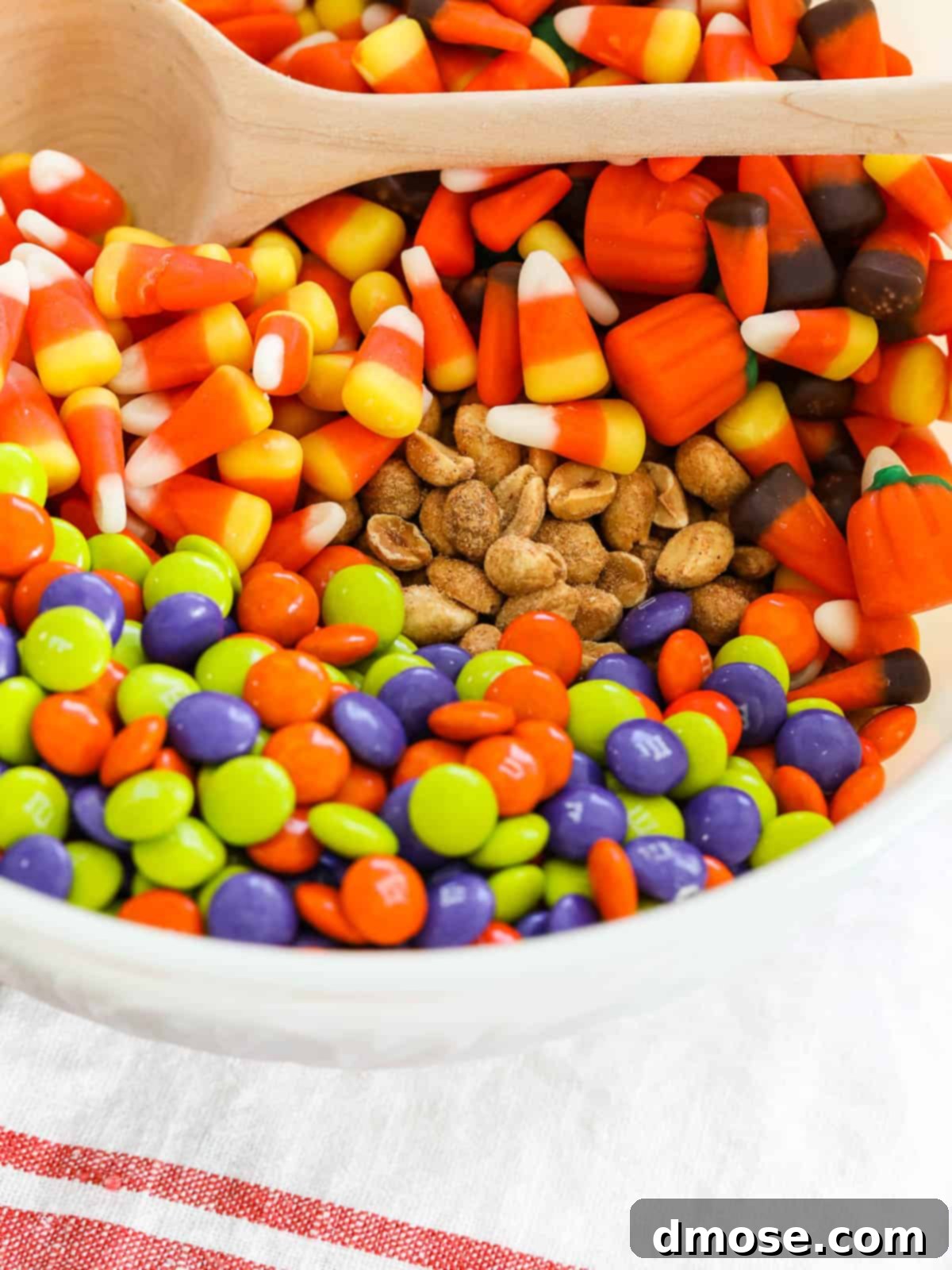 A large, rustic ceramic bowl overflowing with the colorful Fall Snack Mix, ready for serving.