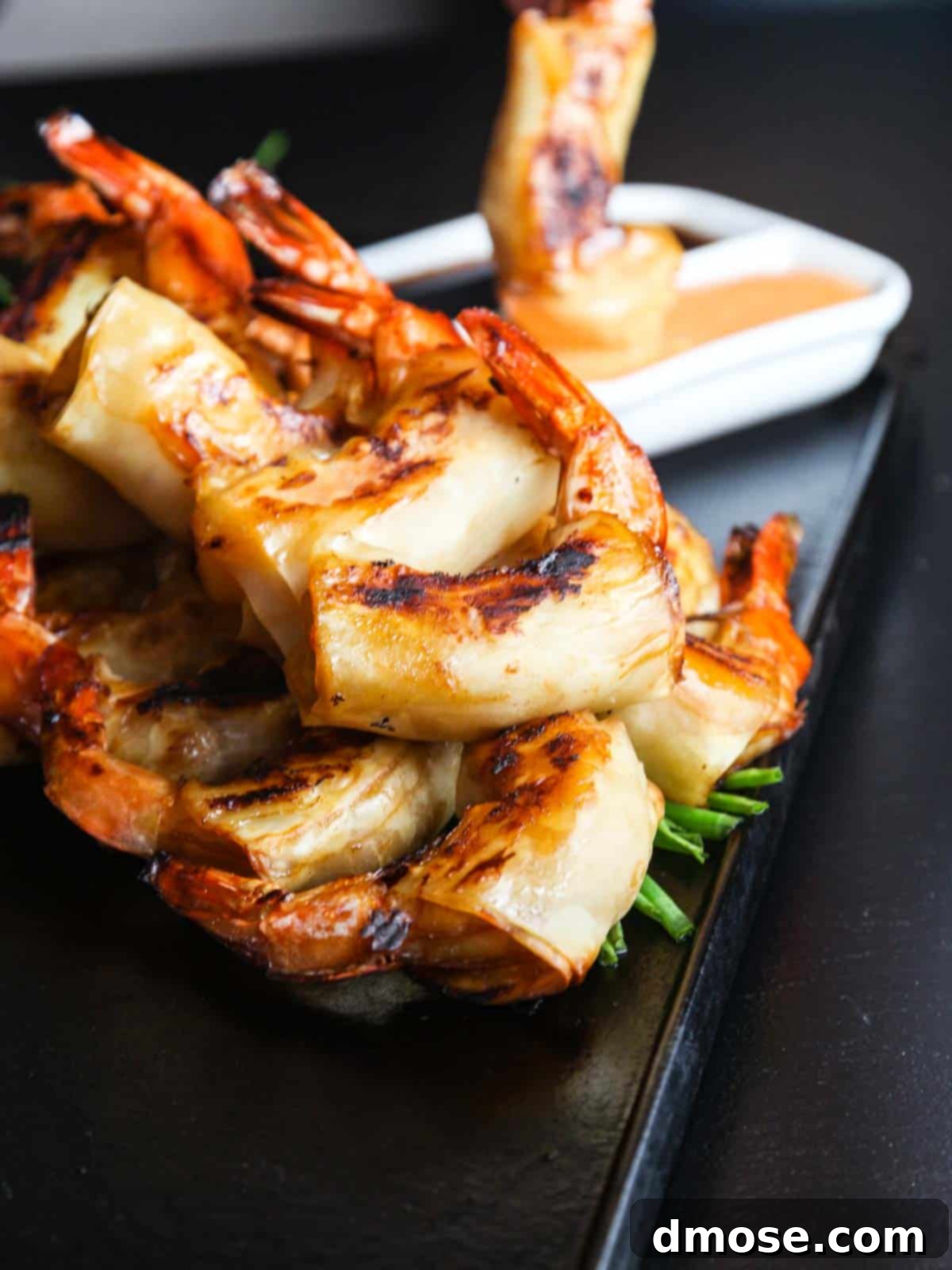 Hot Crispy Shrimp 5 Close-up of Firecracker Shrimp being dipped into sauce in a white bowl.