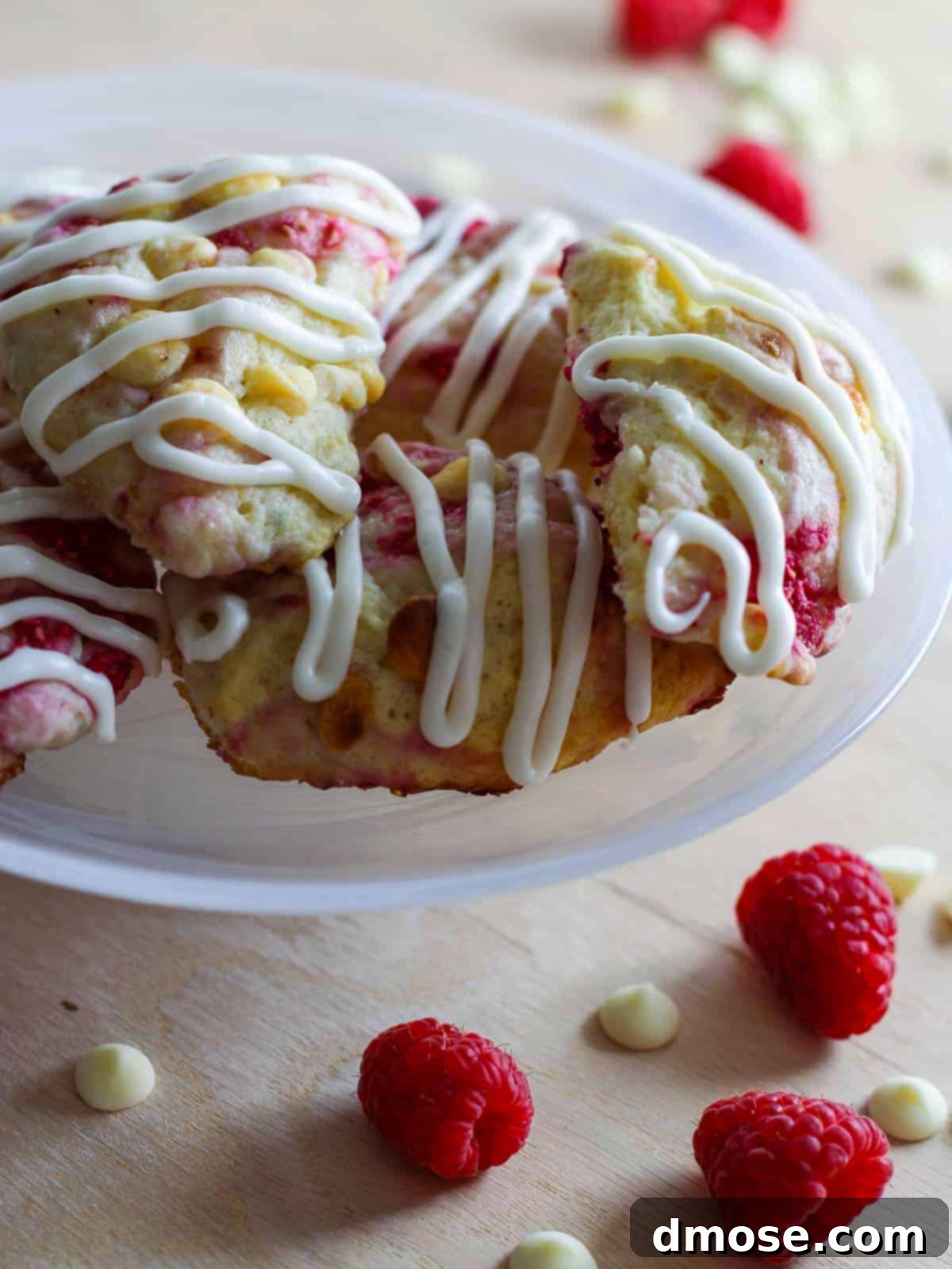 Delicious Raspberry Scones with white chocolate chips and a vanilla icing swirl.
