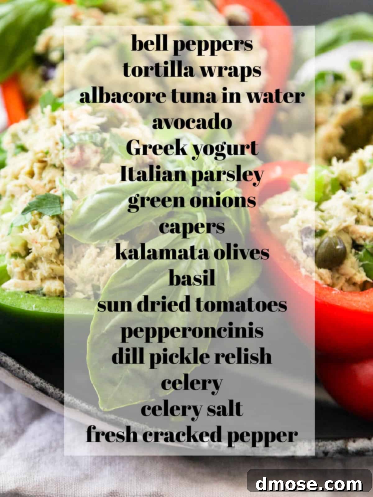 Assortment of fresh ingredients for tuna salad laid out on a wooden cutting board.