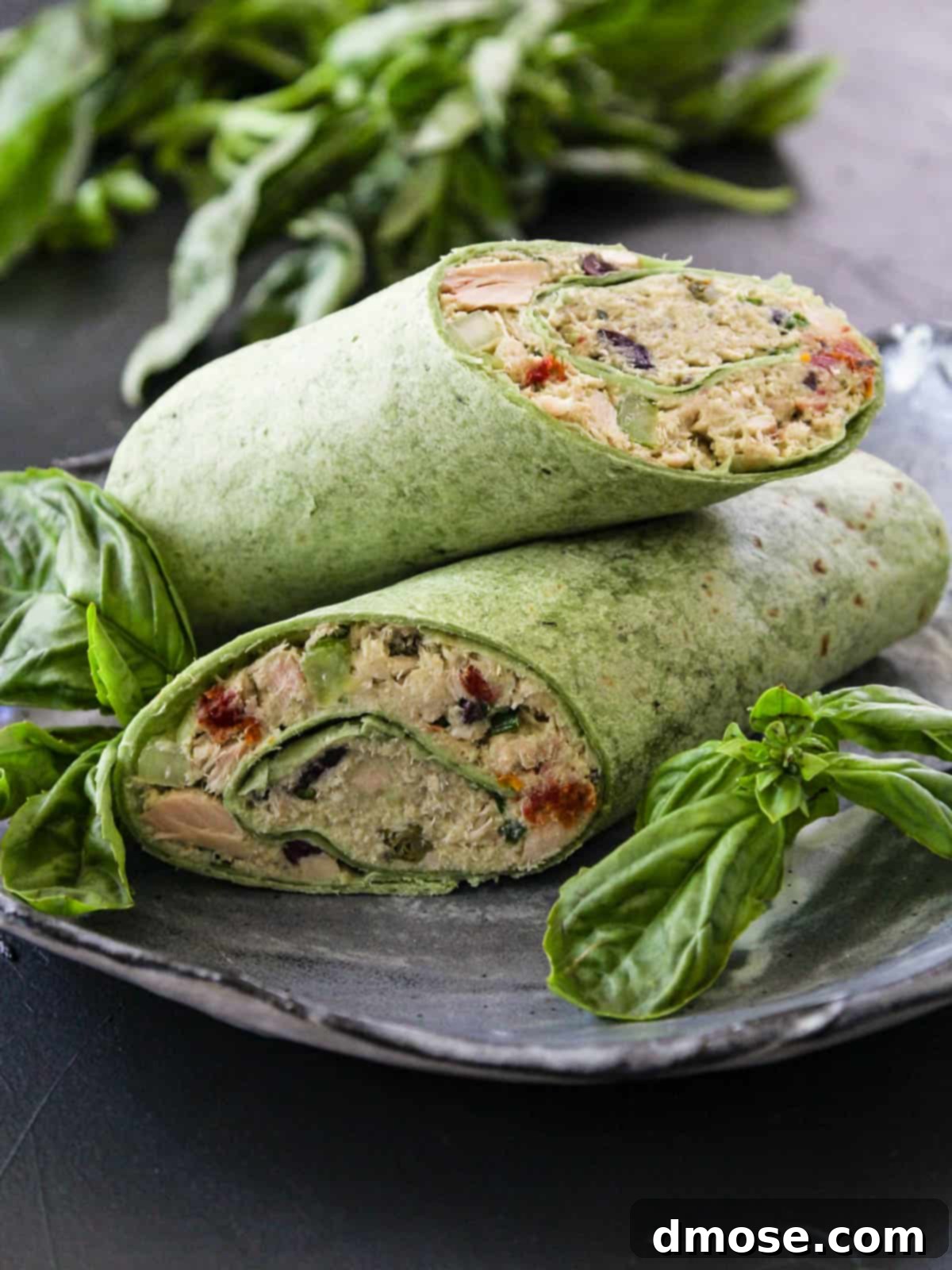 Healthy tuna salad mixed with avocado, Greek yogurt, and colorful vegetables.