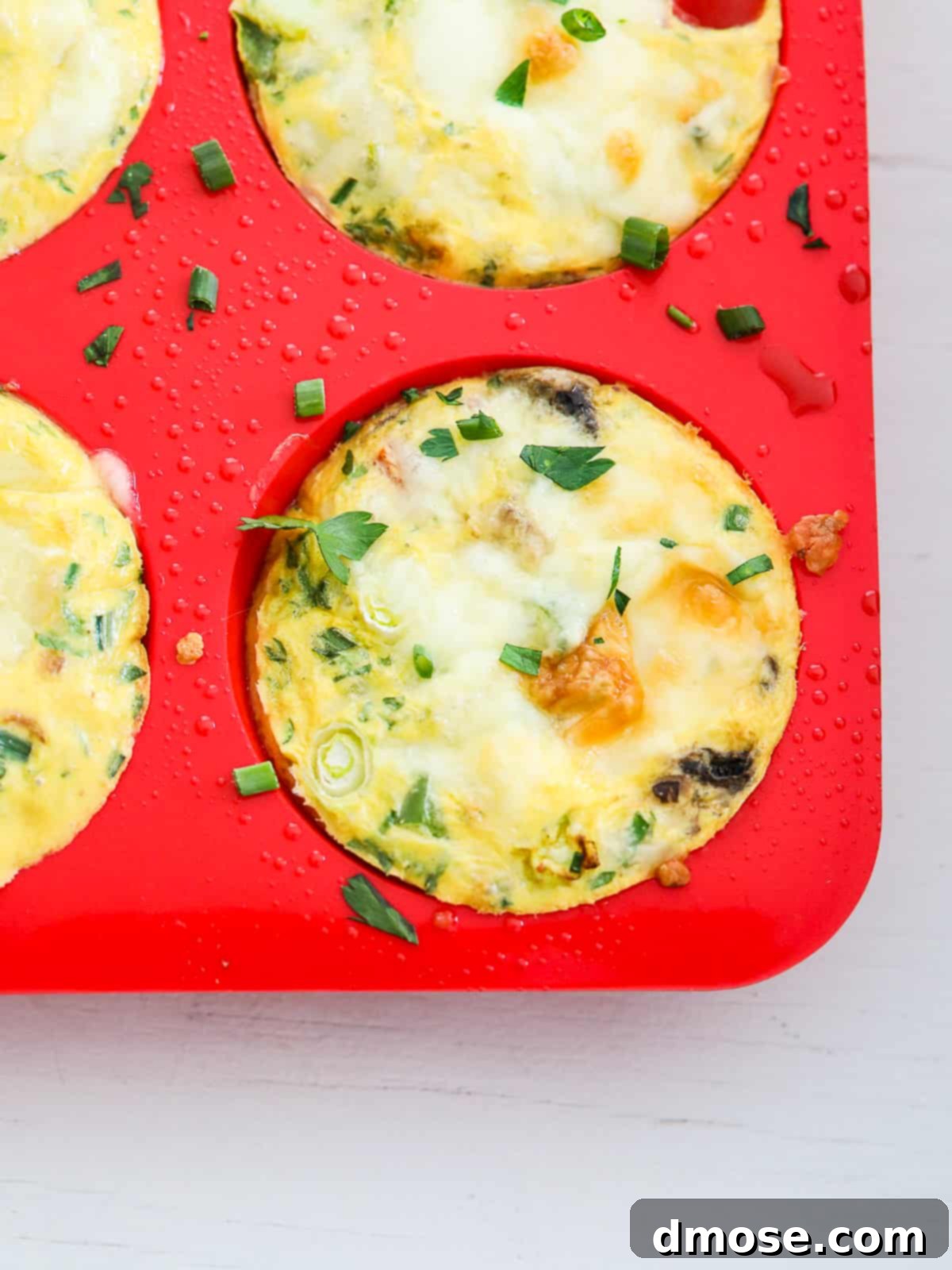 Close-up of baked Egg Muffins in a corner of a muffin tray.
