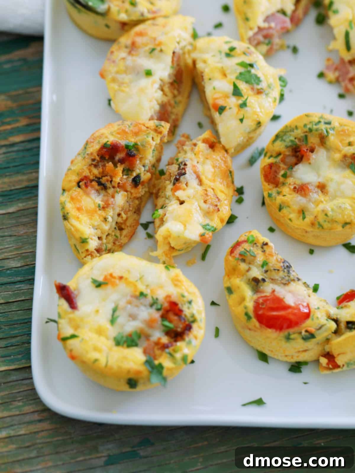 An Egg Muffin cut open on a plate, revealing its fluffy interior and fillings.