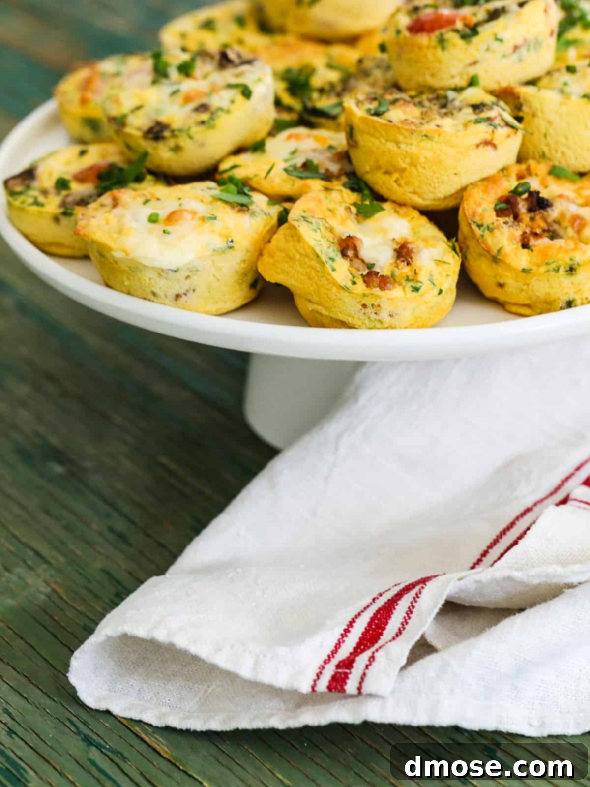 A cake plate filled with a variety of baked Egg Muffins.