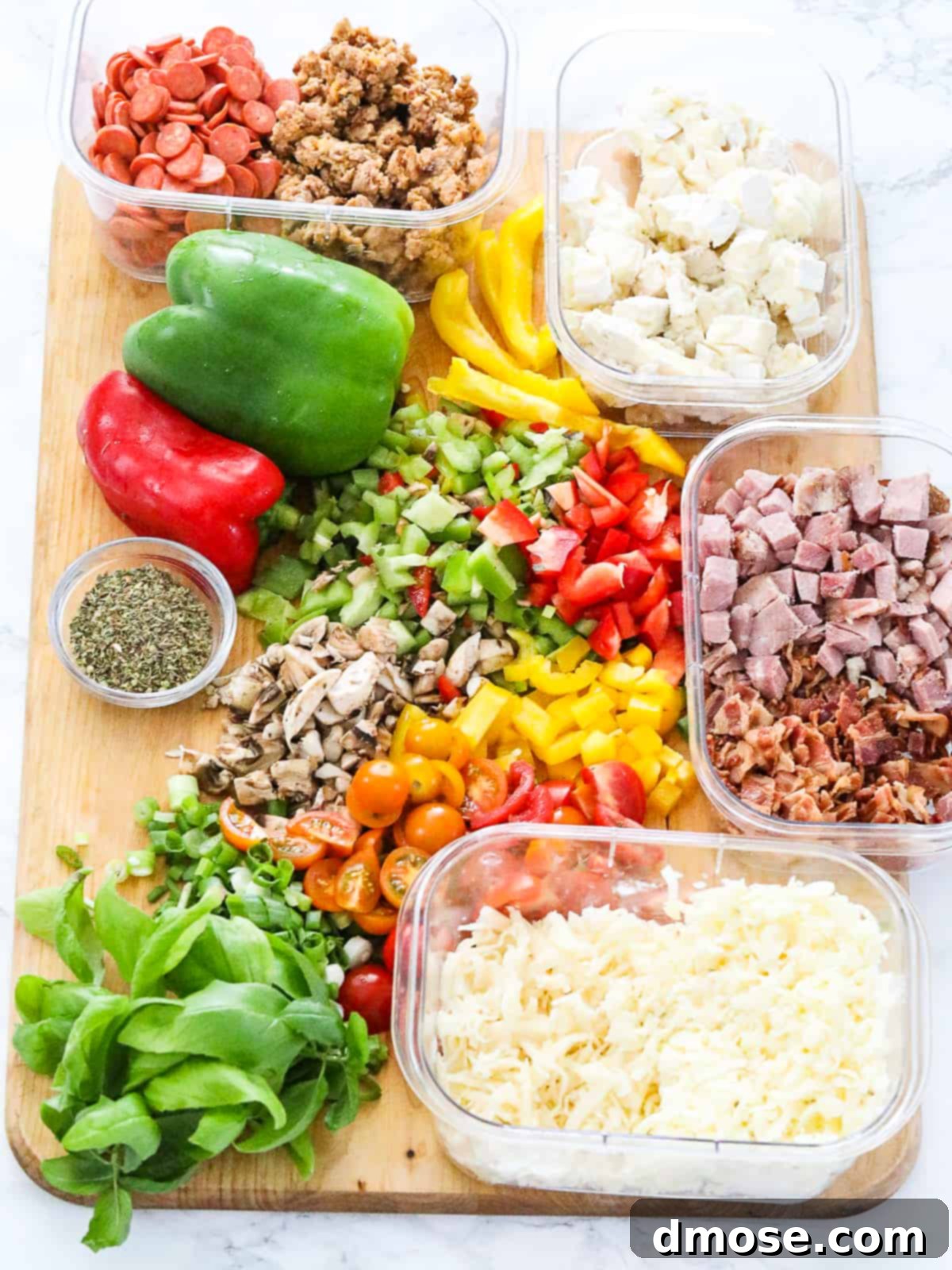 Egg muffins with chopped vegetables and meat toppings before baking.