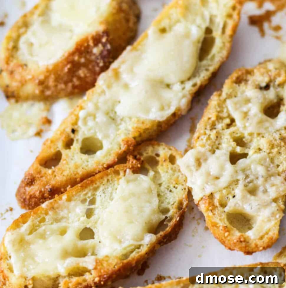 Golden Cheesy Crunch 9 Cheese topped croutons on a parchment lined baking sheet.