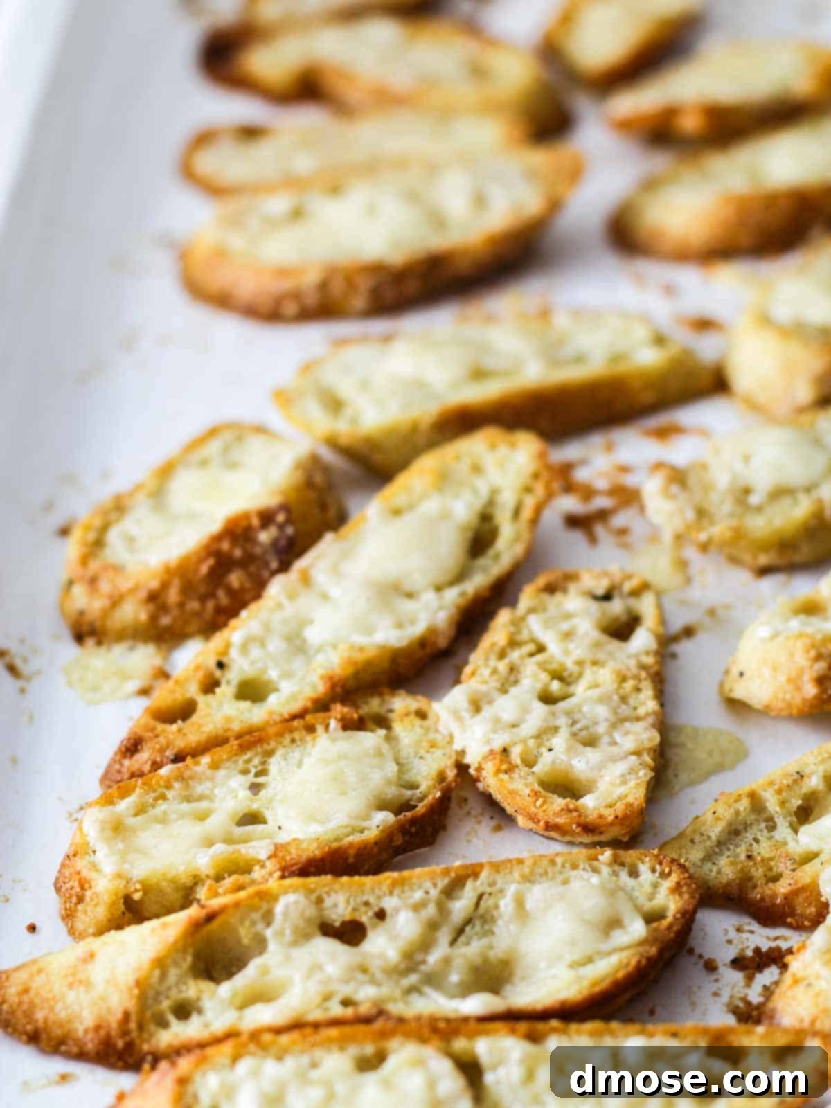 Golden Cheesy Crunch 6 Close-up of crispy baguette croutons on a white plate, ready to be served.