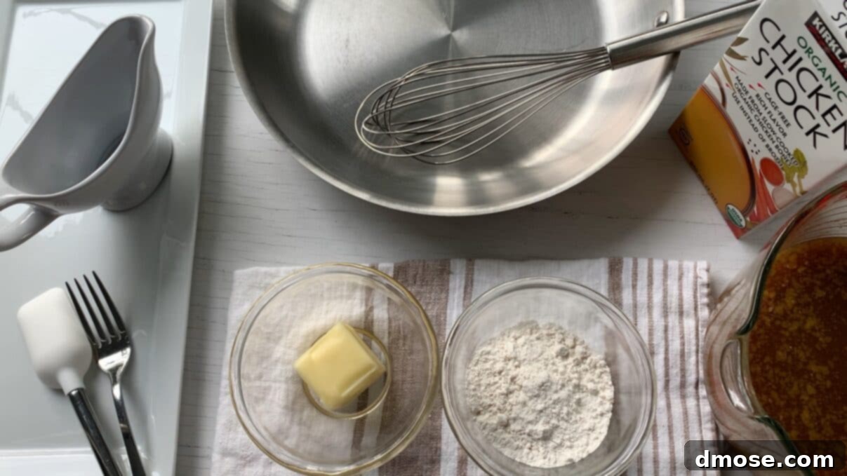 Savory Turkey Gravy 4 A selection of turkey gravy ingredients laid out on a kitchen counter: softened butter, flour, and a container of turkey pan drippings.