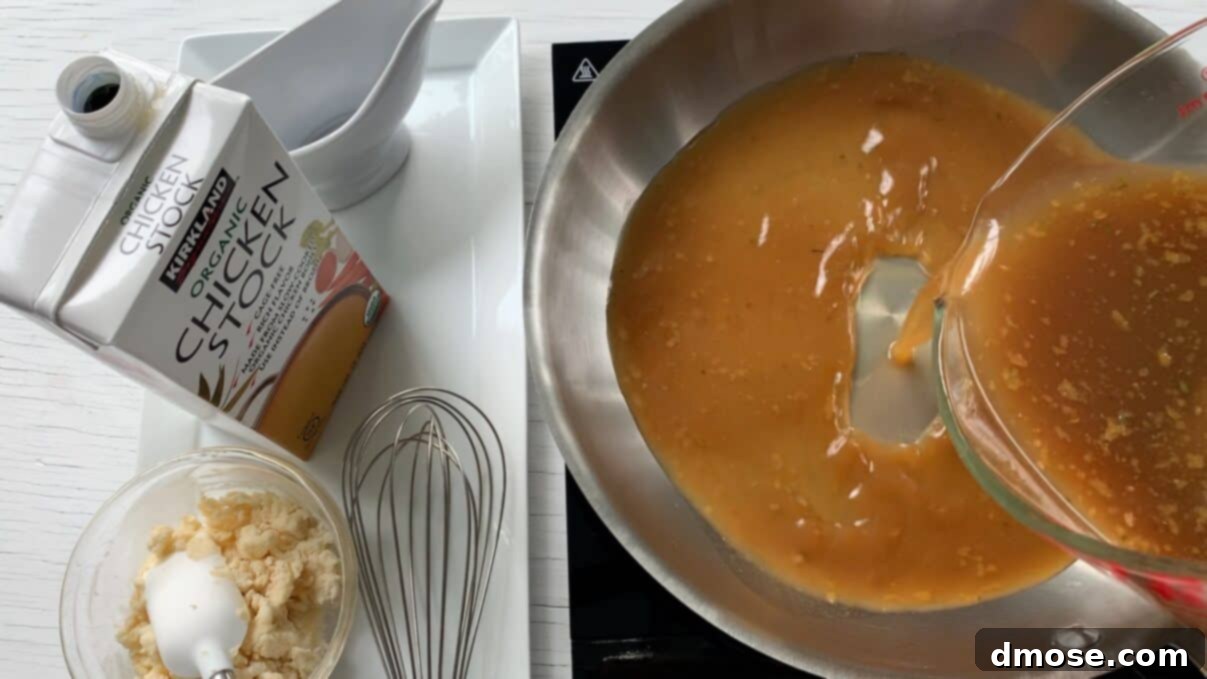 Savory Turkey Gravy 6 Pouring rich turkey pan drippings from a measuring cup into a saucepan on the stovetop.