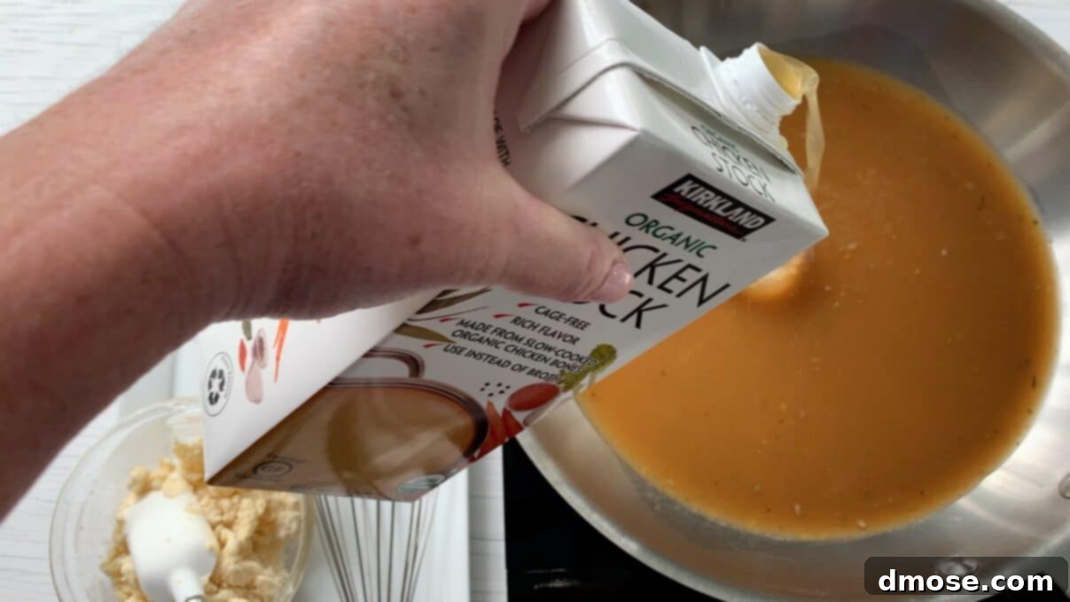 Savory Turkey Gravy 7 Pouring chicken stock from a carton into the saucepan already containing turkey drippings.