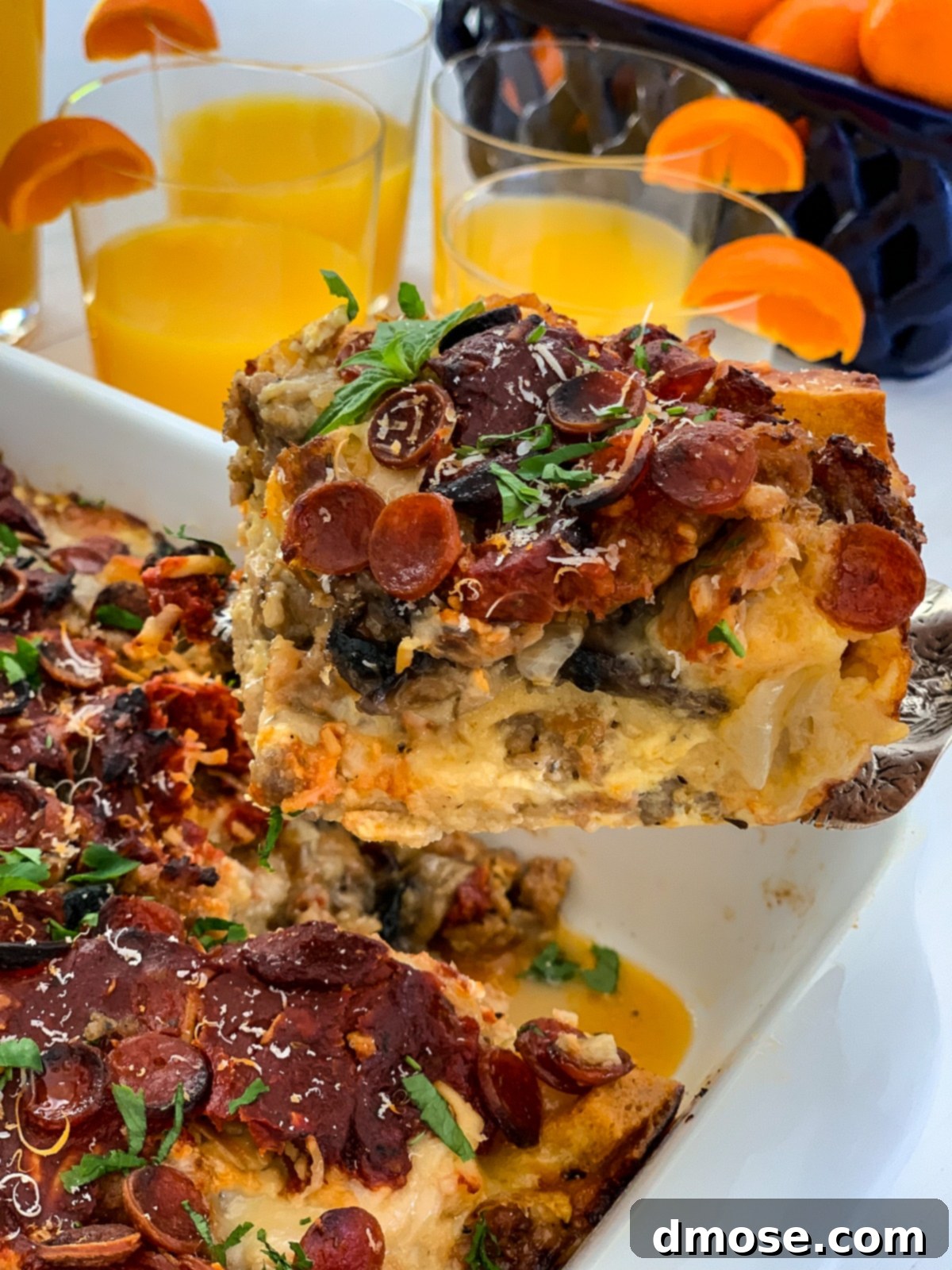 Cheesy Pizza Breakfast Bake 2 Golden-baked pizza breakfast casserole served on a white platter, ready for enjoyment.