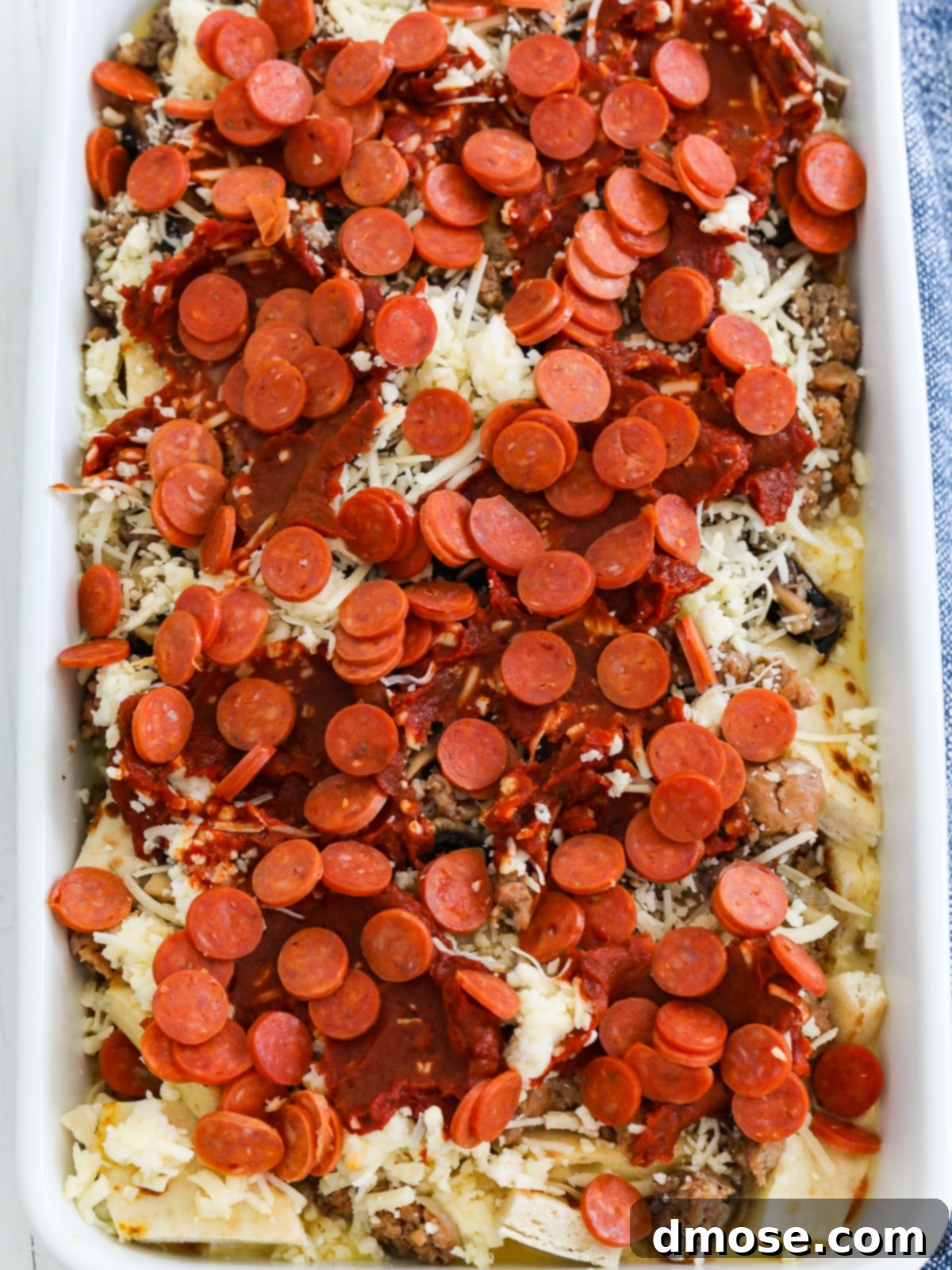 Cheesy Pizza Breakfast Bake 11 Completed breakfast casserole in a white baking dish, ready for baking.