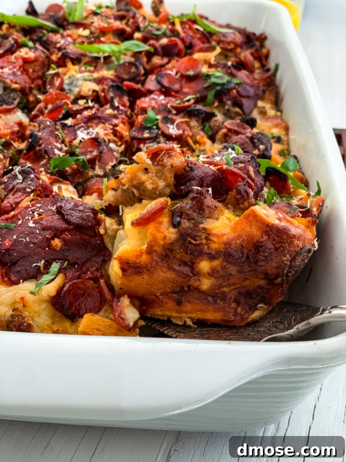 Cheesy Pizza Breakfast Bake 13 Side view of a baked pizza breakfast casserole showing its delicious layers.