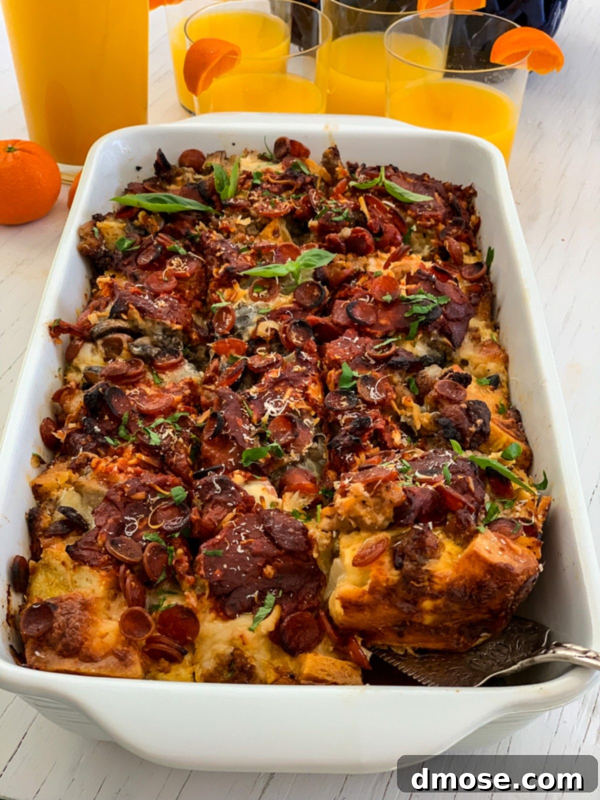 Cheesy Pizza Breakfast Bake 16 A sliced breakfast casserole in a baking dish, showcasing the layers.