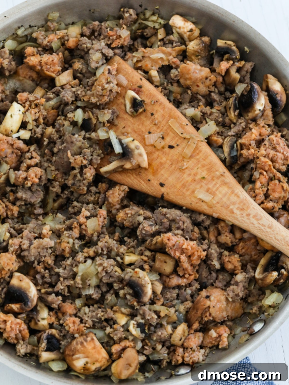 Cheesy Pizza Breakfast Bake 7 A skillet filled with cooked onions and crumbled sausage mixture for the casserole.